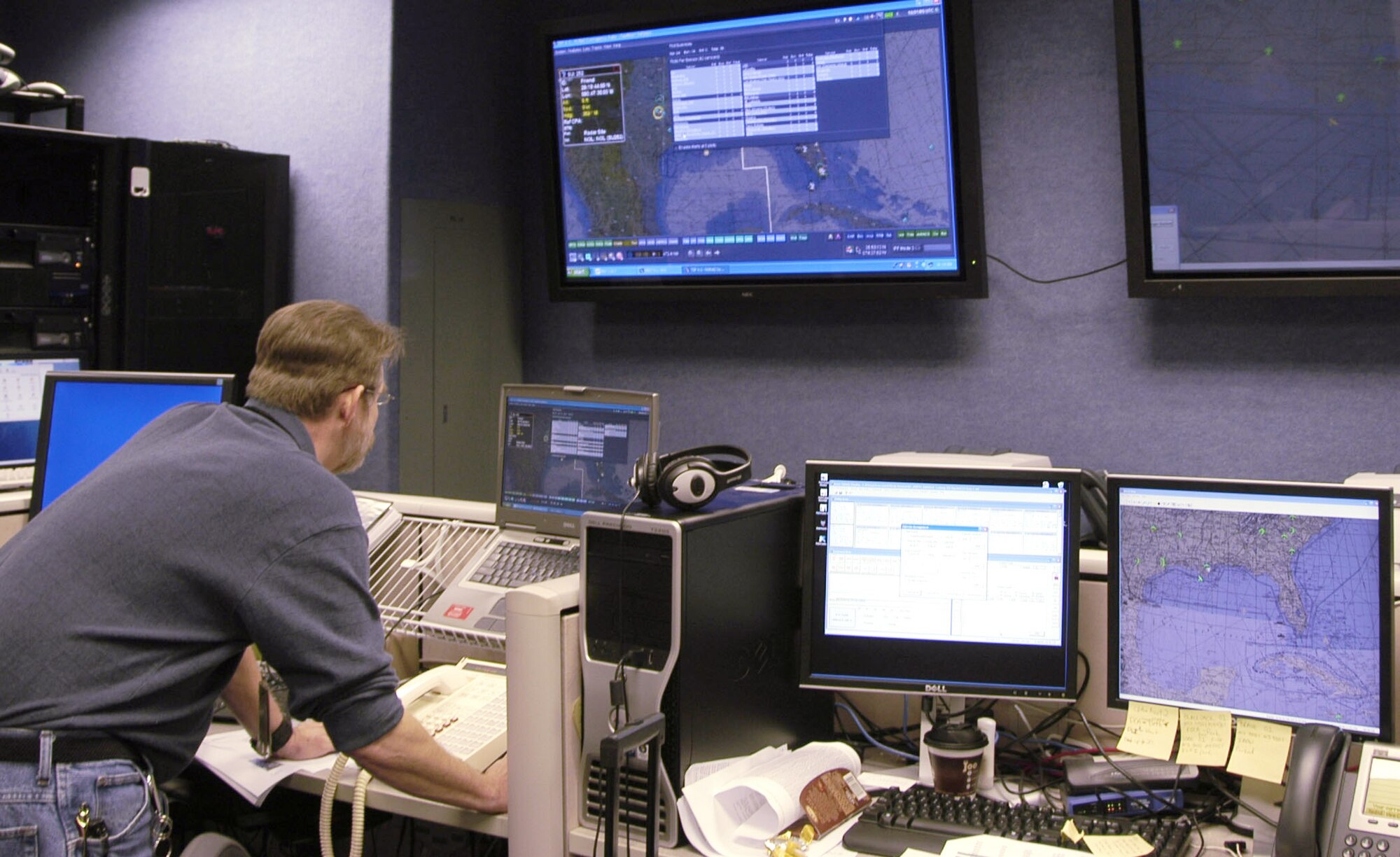 Dwight Herndon, an Aeronautical Radio, Inc., computer network and systems analyst, sets up a training mission using distributed mission operations technology.  (U.S. Air Force photo/Mary McHale) 