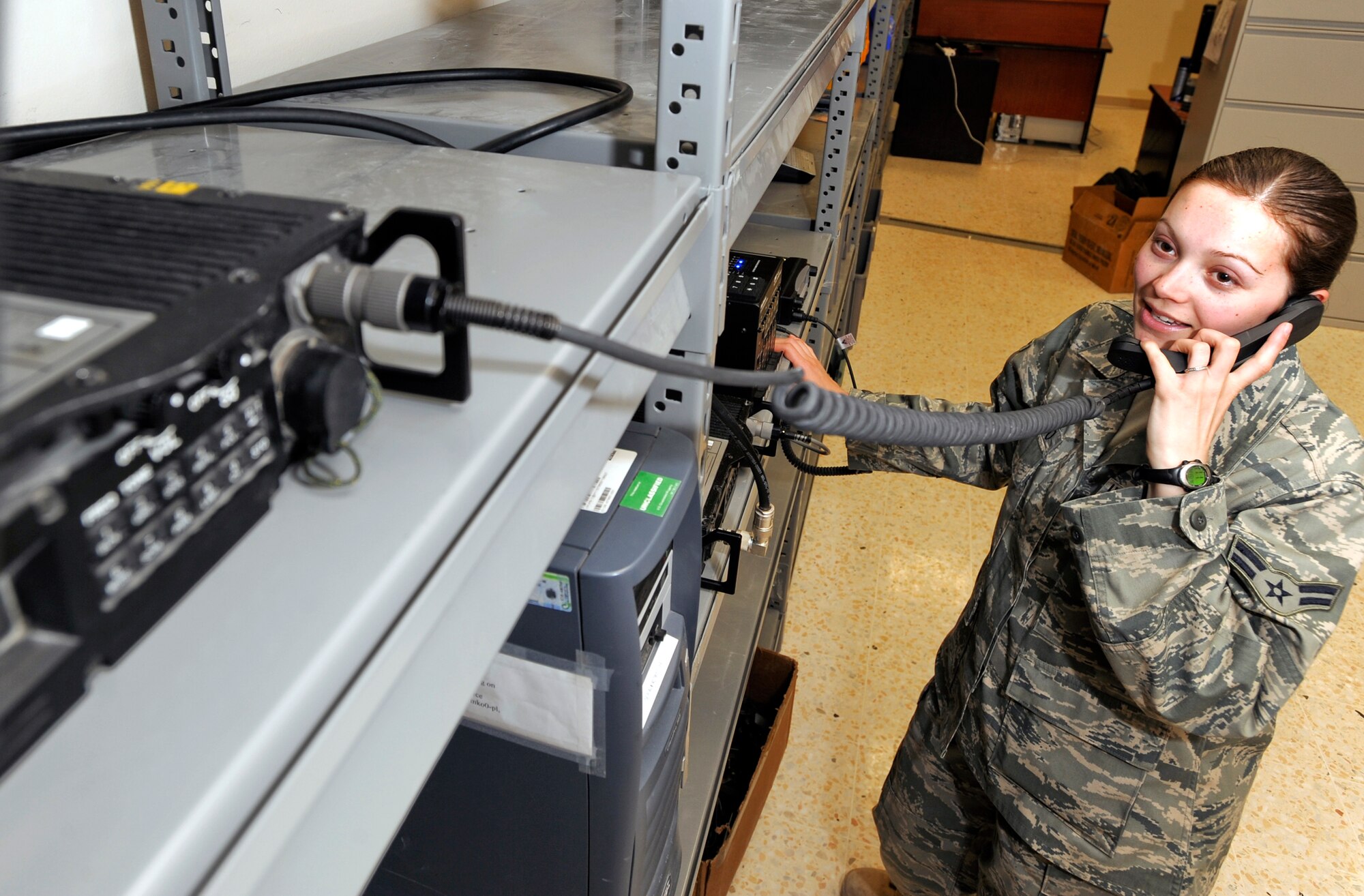 Airman 1st Class Shala "Squeaky" Santiago, a Ground Radio Journeyman from the 379th Expeditionary Communications Squadron, performs a beta test for an Ultra-High Frequency/Very-High Frequency crossband solution. The solution allows people using UHF radios to talk to those with VHF radios; essentially allowing personnel using a land mobile radio to communicate with aircraft in the area if needed. Airman Santiago is native to Colorado Springs, Colo. and is deployed from Elmendorf Air Force Base, Alaska in support of Operations Iraqi and Enduring Freedoms and Combined Joint Task Force - Horn of Africa. (U.S. Air Force Photo by Staff Sgt. Joshua Garcia/released)