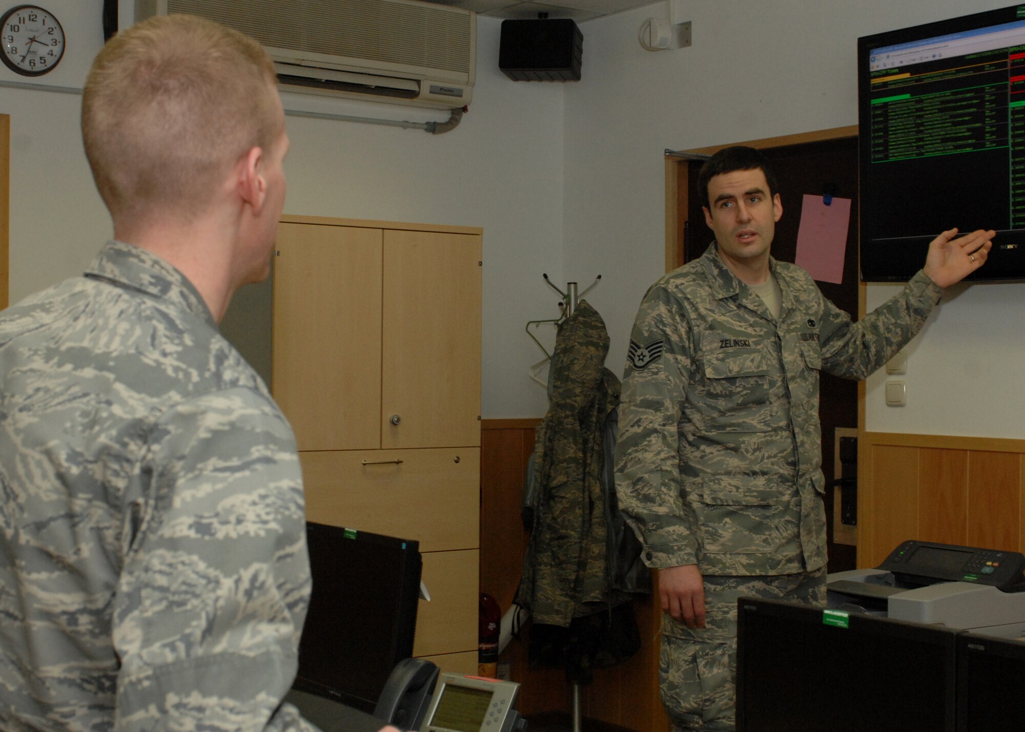 SPANGDAHLEM AIR BASE, Germany -- Staff Sgt. John Zelinski briefs 2nd Lt. Trek Potter, both from the 52nd Communications Squadron, about how customers’ trouble tickets are handled Feb. 13, 2009.  Members from across the 52nd Fighter Wing are doing final preparation for the inspection, scheduled from Feb. 23-27, 2009. (U.S. Air Force photo by Senior Airman Jenifer H. Calhoun)