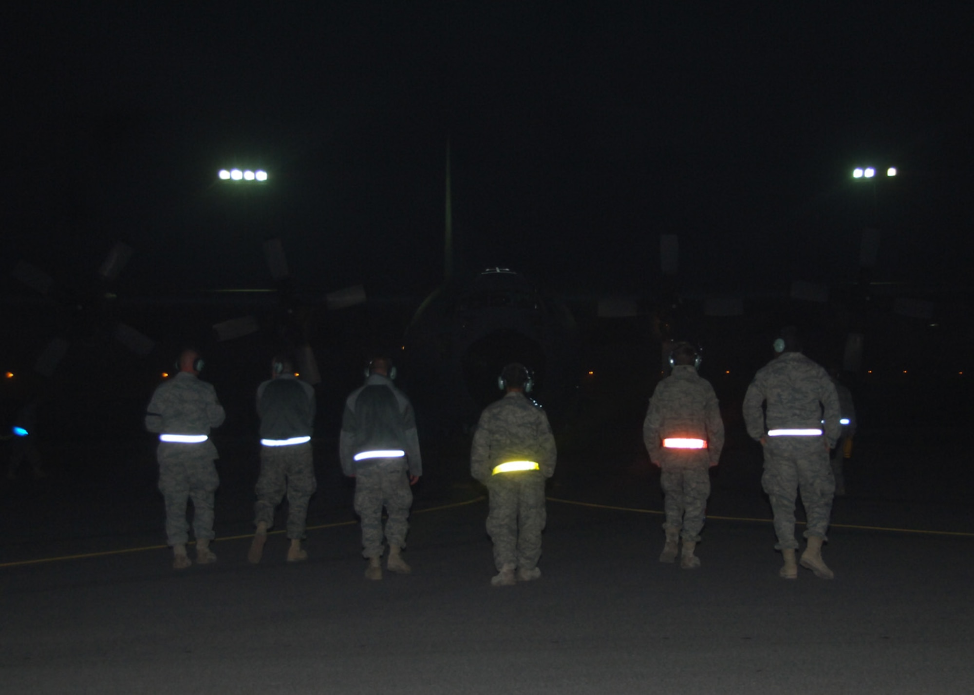 SOUTHWEST ASIA -- Maintainers from the 43rd Expeditionary Electronic Combat Squadron proceed to the EC-130 in preparation for system and maintenance checks after it landed at an air base in Southwest Asia, Feb. 17. The 43rd EECS had just completed its 20,000 combat flight hours after five years of continuous deployment. (U.S. Air Force photo/ Senior Airman Courtney Richardson)