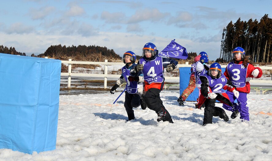 MISAWA AIR BASE, Japan -- Members of Team Jets race up to the front barrier during a snowball fight competition between Japanese and American children Feb. 14, 2009, in Misawa City. The event, which was hosted by the Tohoku Defense Bureau, took place at the Tonami Clan Memorial Village. (U.S. Air Force photo by Senior Airman Chad Strohmeyer)