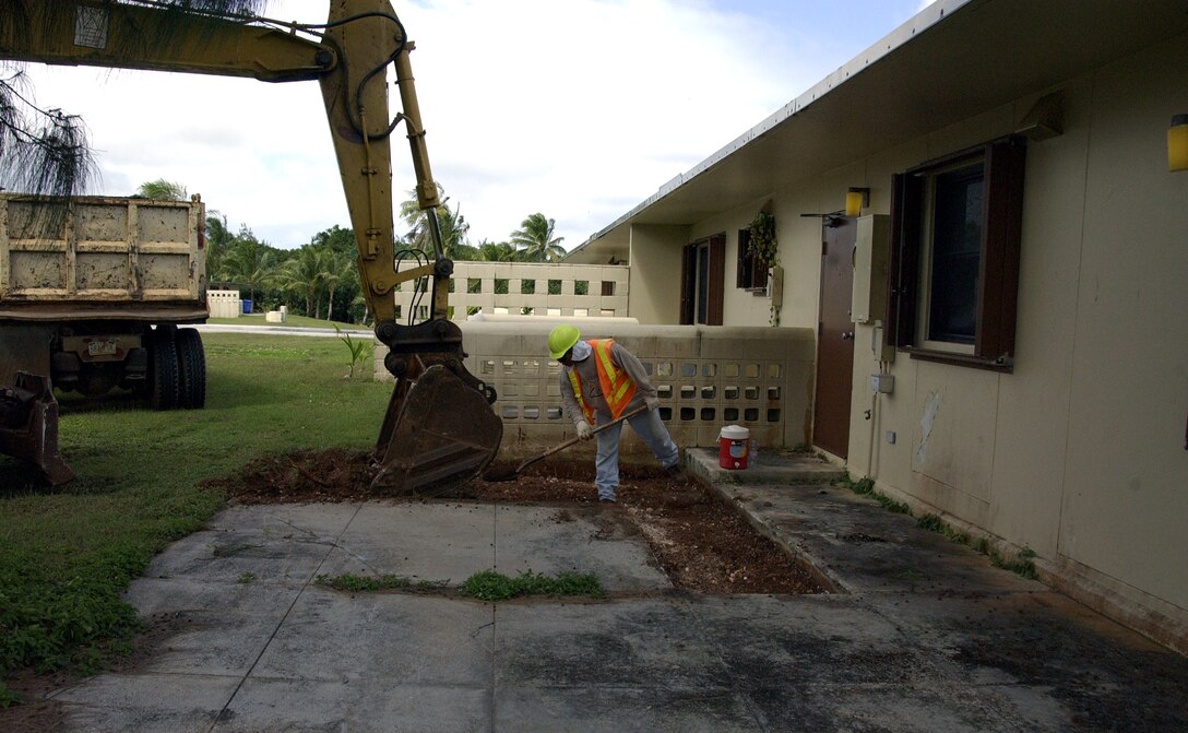 ANDERSEN AIR FORCE BASE, Guam -- Larry Cabantting, a Guam Construction Company contractor, helps an associate level a patio Feb. 17 here. Nearly 400 patios are being replaced in base housing, totalling about $1 million in repairs. (U.S. Air Force photo by Airman 1st Class Carissa Wolff)