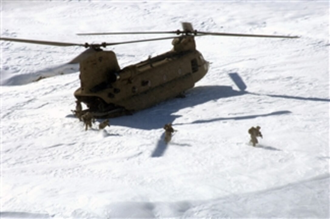 U.S. Army soldiers from Alpha Company, 1st Platoon, Personnel Security Detail, 101st Airborne Division exit a CH-47 Chinook helicopter to provide security in Bagram, Afghanistan, on Feb. 15, 2009.  
