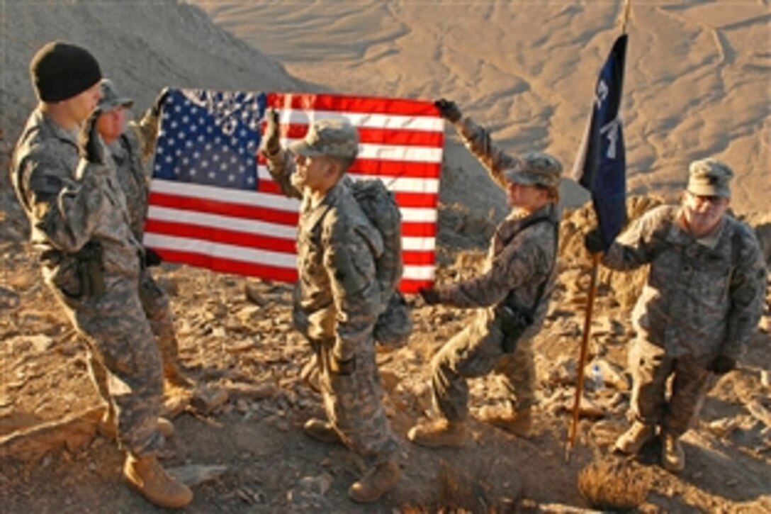 U.S. Army Capt. Michael Riha, left, re-enlists Spc. Rodriguez on top of Ghar Mountain at Kabul Military Training Center in Kabul, Afghanistan, Feb. 6, 2009. The soldiers assigned to Delta Security Force made the early morning climb to re-enlist four soldiers.