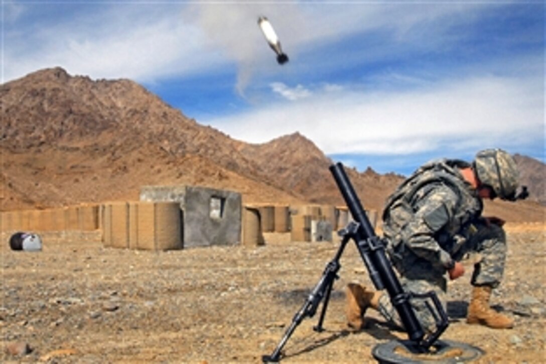 U.S. Army Pvt. Jeffery Hansen crouches after launching a 60mm mortar round from the mortar range on Forward Operating Base Lane in Zabul Province, Afghanistan, Feb. 15, 2009. Hansen is assigned to Company B, 1st Battalion, 4th Infantry Regiment.