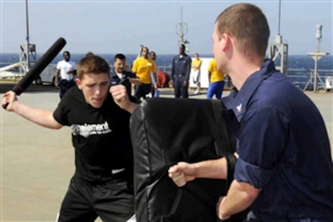 U.S. Navy Seaman Chad Tomes demonstrates a self-defensive baton striking technique during a non-lethal weapons course aboard USS Blue Ridge while underway in the Pacific Ocean, Feb. 13, 2009.