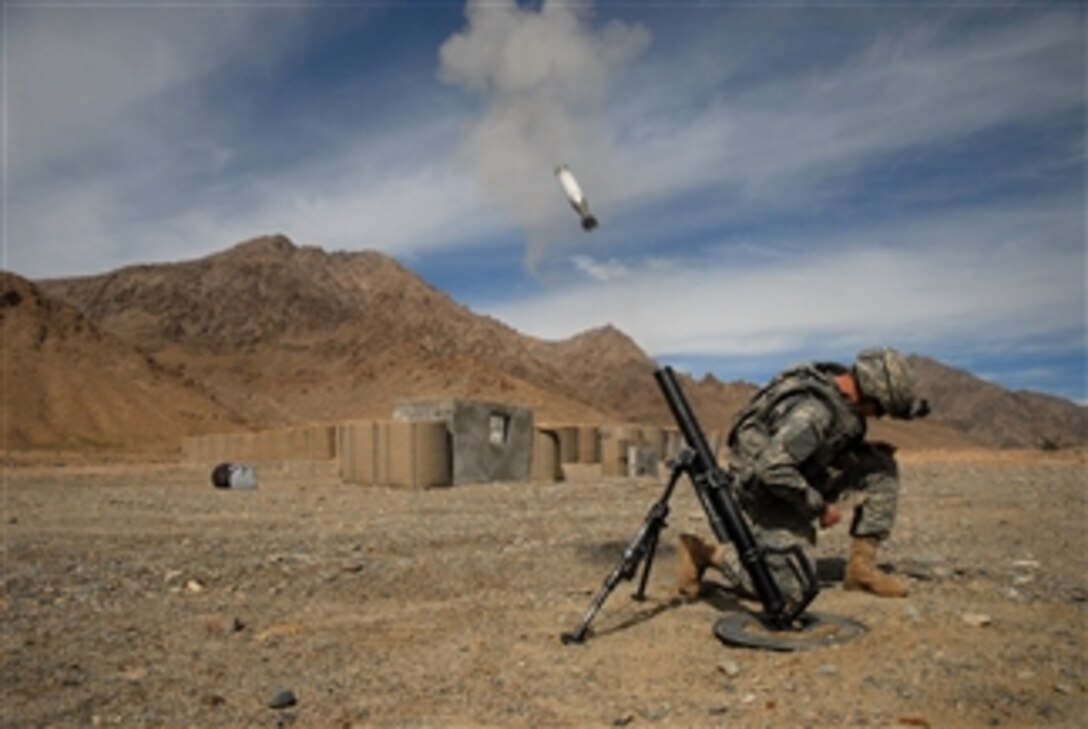 090215-A-6797M-095 
       U.S. Army Pvt. Jeffery Hansen crouches down after launching a 60mm mortar round on a range at Forward Operating Base Lane in Afghanistan on Feb. 15, 2009.  Hansen is assigned to Bravo Company, 1st Battalion, 4th Infantry Regiment.  