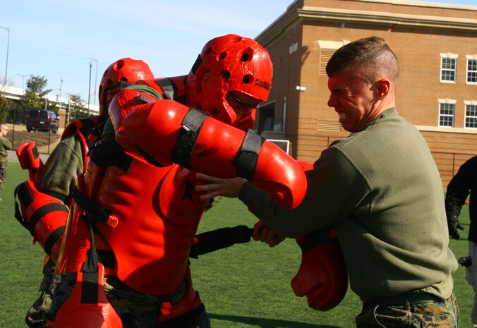 Sgt. Logan Wilburn, 2nd platoon sergeant, Bravo Company, Marine Barracks Washington, assaults a training dummy after getting sprayed in the face with a potent chemical during nonlethal tactics training at Marine Barracks Washington, Feb. 17. Logan, among many others, would qualify as a user and instructor of oleoresin capsicum, or OC spray.