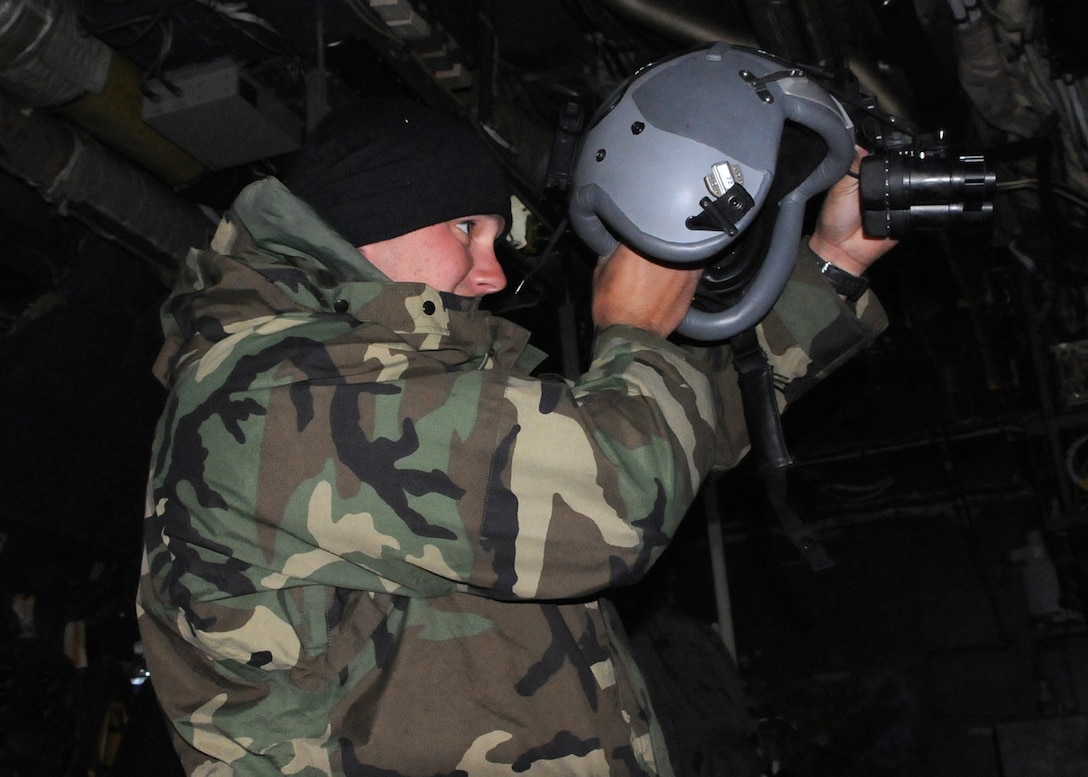 DAEGU AIR BASE, Republic of Korea -- Staff Sgt. Timothy Haag, a 353rd Special Operations Group Forward Area Refueling Point specialist, performs a final inspection on his helmet and night-vision goggles onboard a MC-130P Combat Shadow shortly before a refueling mission at a forward area refueling point here Feb. 12. FARP specialists and loadmasters utilize a forward area manifold cart to transfer fuel from one aircraft to another in hostile and austere environments.  The group's seven member FARP team is one of five locations with an active FARP program; and covers the largest geographical area with almost 30 active FARP sites. (U.S. Air Force photo by Tech. Sgt. Aaron Cram)