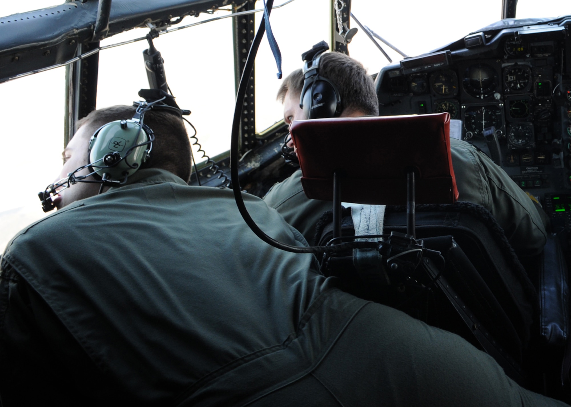 OSAN AIR BASE, Republic of Korea -- Capt. Casey Moores, the mission commander and  a 17th Special Operations Squadron pilot, and Senior Airman Joshua Baker, a 17th SOS flight engineer, look to confirm a leak from one of the engines during a training mission over the Republic of Korea peninsula Feb. 9. Sixteen members from the 17th SOS, the 353rd Special Operations Group Forward Area Refueling Point Team, 353rd Maintenance Squadron and Detachment 3 of 25th Intelligence Squadron, conducted training in the Republic of Korea Feb. 9 - 12 to ensure they are ready to fulfill their duties as the only Air Force special operations unit permanently assigned in the U.S. Pacific Command theater. (U.S. Air Force photo by Tech. Sgt. Aaron Cram)