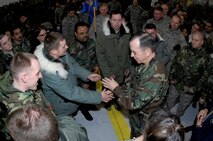 MINOT AIR FORCE BASE, N.D. -- Navy Adm. Michael G. Mullen, chairman of the Joint Chiefs of Staff, presents a coin to an Airman during an all-call at Dock 1 here Feb. 18. During the event, Admiral Mullen talked with Airmen about the importance of family support, concerns over the economic crisis and Minot AFB’s role in nuclear deterrence as the Air Force’s only dual-wing, nuclear-capable base. Admiral Mullen is the first CJCS to visit the base in more than 20 years. (U.S. Air Force photo by Airman 1st Class Jesse Lopez)