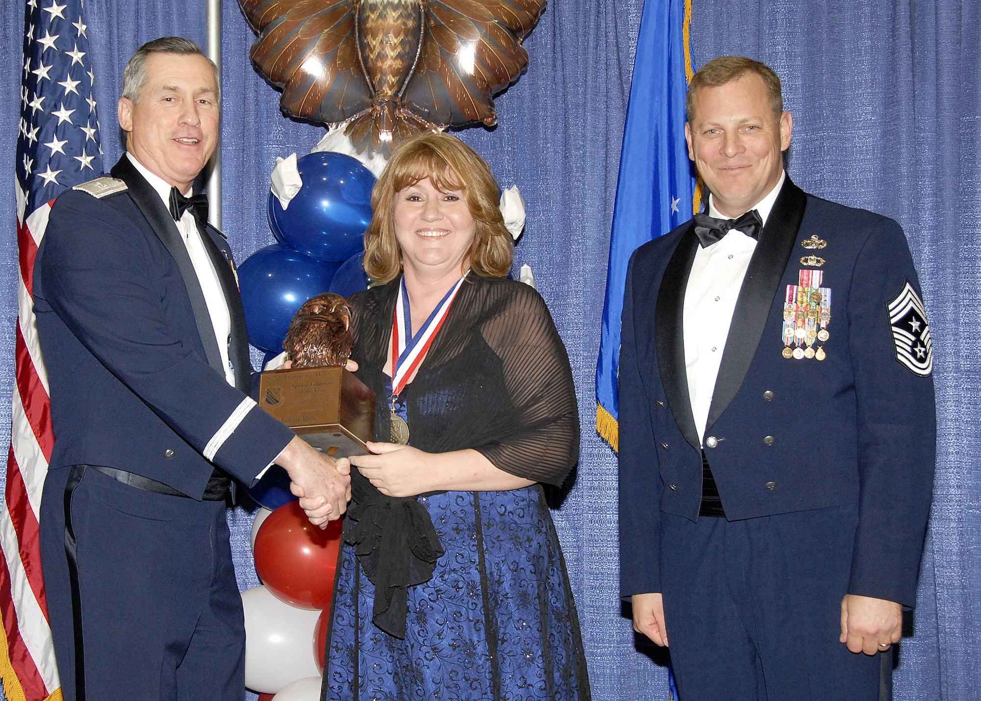 Janeen Mills, 782nd Training Group, accepts the Spouse Volunteer of the Year award on Feb. 13 from 82nd Training Wing Commander Brig. Gen. O.G. Mannon during the Annual Awards Banquet at the Multi Purpose Event Center. Also pictured is 82nd TRW Command Chief Master Sgt. Kenneth Sallinger. (U.S. Air Force photo/Lou Anne Sledge) 