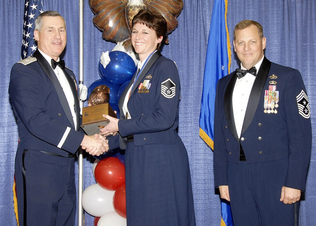 Master Sgt. Dana Fogle, 82nd Mission Group, accepts the Additional Duty First Sergeant of the Year award on Feb. 13 from 82nd Training Wing Commander Brig. Gen. O.G. Mannon during the Annual Awards Banquet at the Multi Purpose Event Center. Also pictured is 82nd TRW Command Chief Master Sgt. Kenneth Sallinger. (U.S. Air Force photo/Lou Anne Sledge) 
