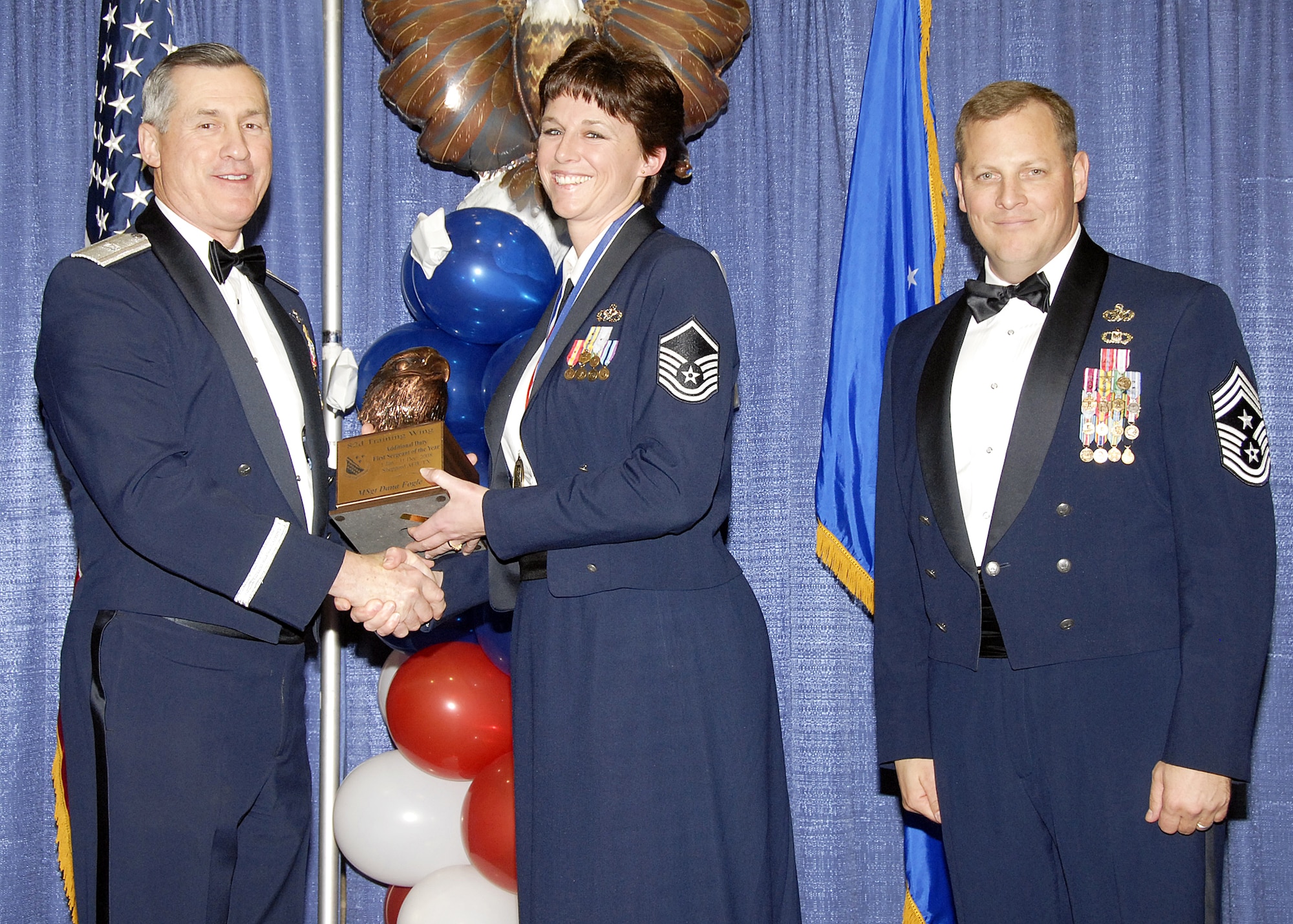 Master Sgt. Dana Fogle, 82nd Mission Group, accepts the Additional Duty First Sergeant of the Year award on Feb. 13 from 82nd Training Wing Commander Brig. Gen. O.G. Mannon during the Annual Awards Banquet at the Multi Purpose Event Center. Also pictured is 82nd TRW Command Chief Master Sgt. Kenneth Sallinger. (U.S. Air Force photo/Lou Anne Sledge) 