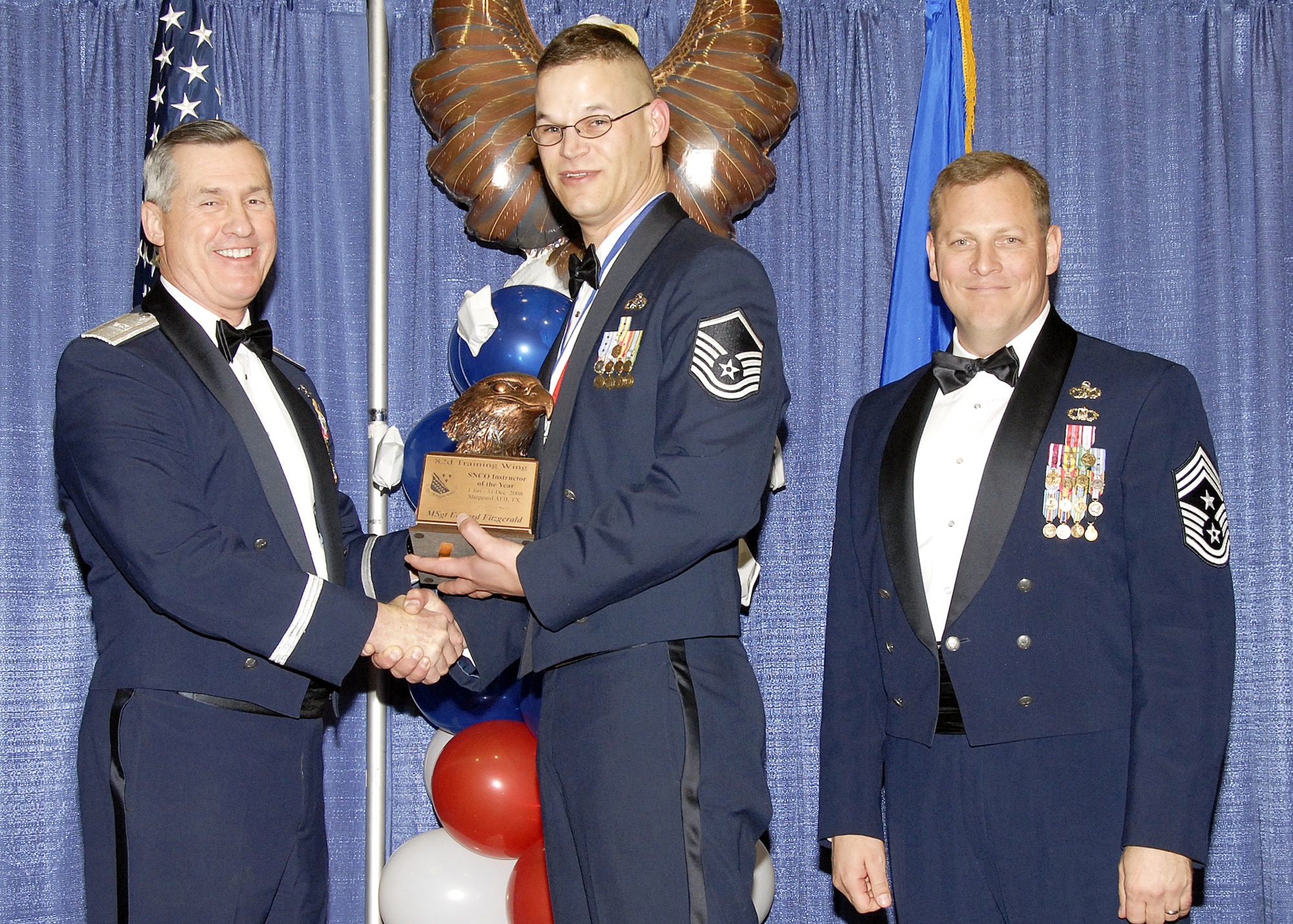 Master Sgt. Edward Fitzgerald, 782nd Training Group, accepts the Senior NCO Instructor of the Year award on Feb. 13 from 82nd Training Wing Commander Brig. Gen. O.G. Mannon during the Annual Awards Banquet at the Multi Purpose Event Center. Also pictured is 82nd TRW Command Chief Master Sgt. Kenneth Sallinger. (U.S. Air Force photo/Lou Anne Sledge) 