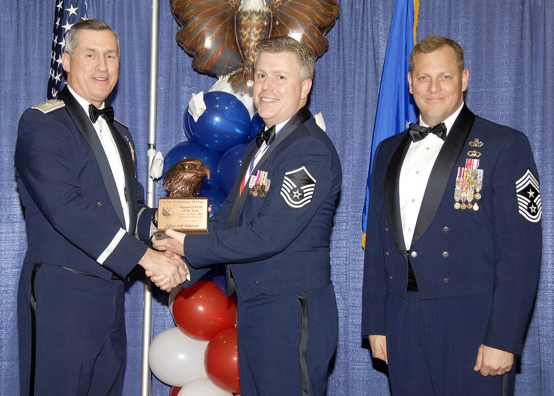 Master Sgt. Jeff Johnson, 882nd Training Group, accepts the Support Senior NCO of the Year award on Feb. 13 from 82nd Training Wing Commander Brig. Gen. O.G. Mannon during the Annual Awards Banquet at the Multi Purpose Event Center. Also pictured is 82nd TRW Command Chief Master Sgt. Kenneth Sallinger. (U.S. Air Force photo/Lou Anne Sledge) 