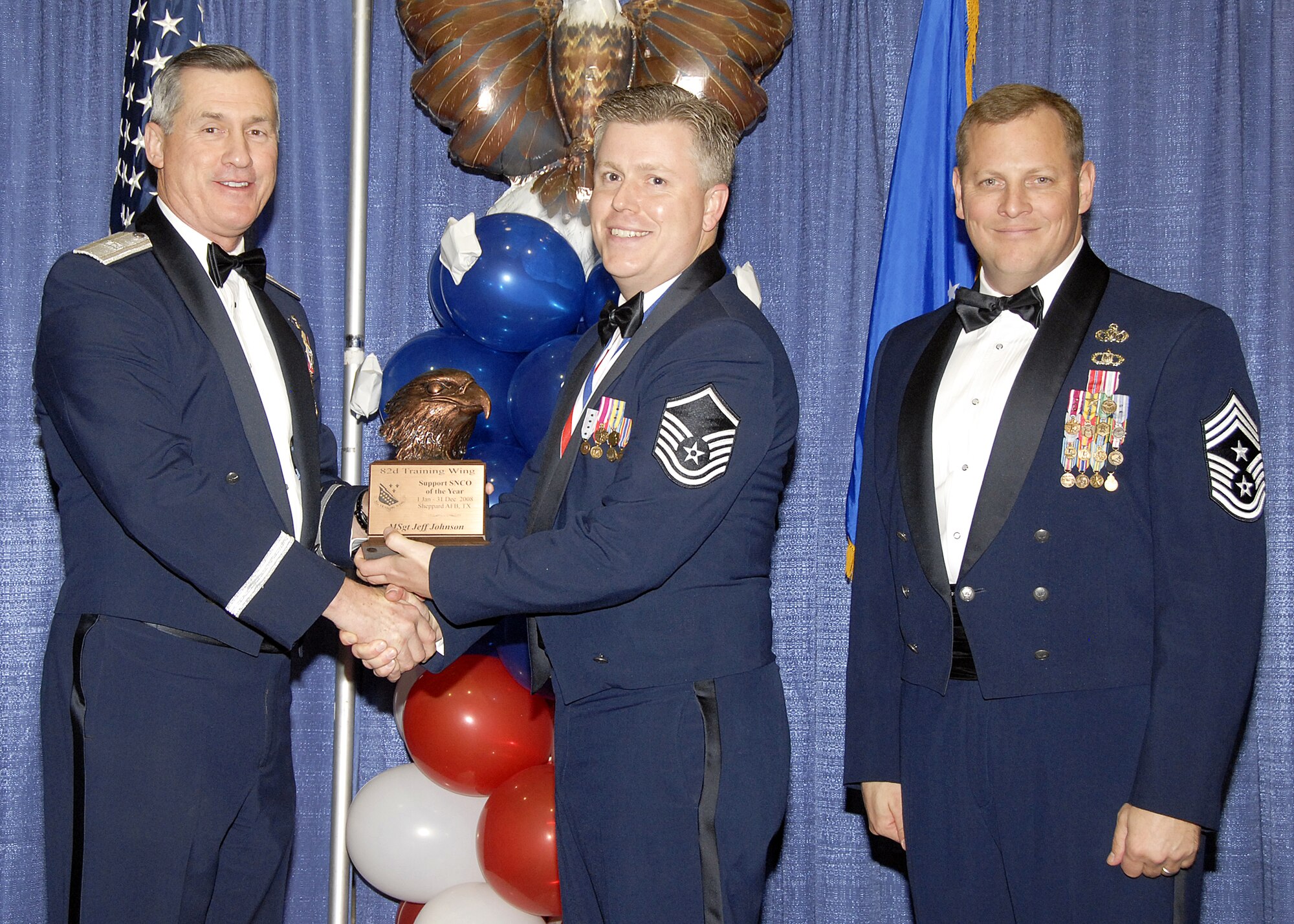 Master Sgt. Jeff Johnson, 882nd Training Group, accepts the Support Senior NCO of the Year award on Feb. 13 from 82nd Training Wing Commander Brig. Gen. O.G. Mannon during the Annual Awards Banquet at the Multi Purpose Event Center. Also pictured is 82nd TRW Command Chief Master Sgt. Kenneth Sallinger. (U.S. Air Force photo/Lou Anne Sledge) 