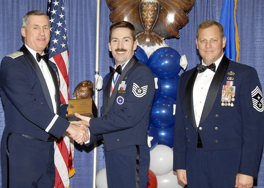 Tech. Sgt. Scott Turner, 982nd Training Group, accepts the NCO of the Year award on Feb. 13 from 82nd Training Wing Commander Brig. Gen. O.G. Mannon during the Annual Awards Banquet at the Multi Purpose Event Center. Also pictured is 82nd TRW Command Chief Master Sgt. Kenneth Sallinger. (U.S. Air Force photo/Lou Anne Sledge) 