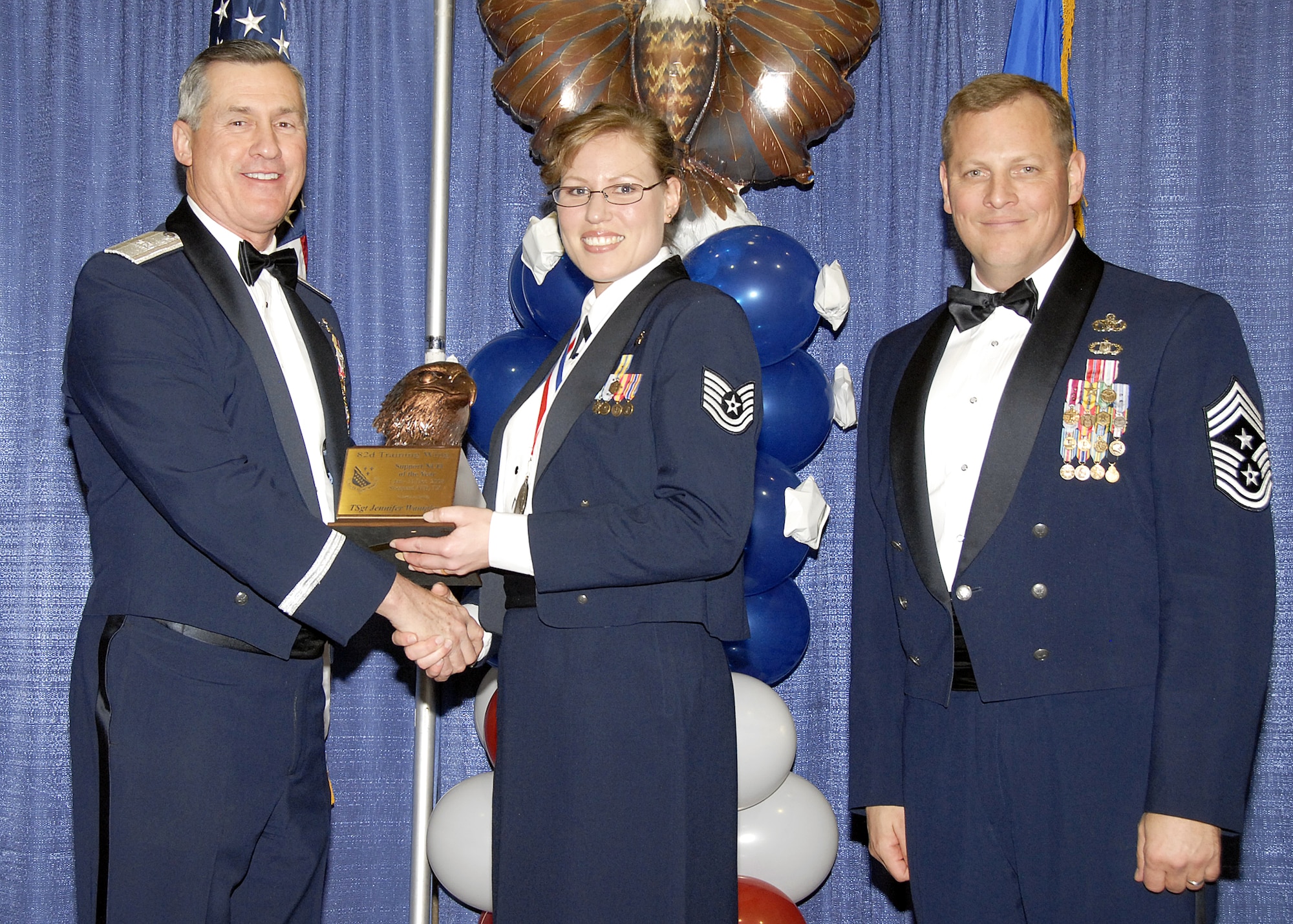 Tech. Sgt. Jennifer Wampler, 882nd Training Group, accepts the Support NCO of the Year award on Feb. 13 from 82nd Training Wing Commander Brig. Gen. O.G. Mannon during the Annual Awards Banquet at the Multi Purpose Event Center. Also pictured is 82nd TRW Command Chief Master Sgt. Kenneth Sallinger. (U.S. Air Force photo/Lou Anne Sledge) 