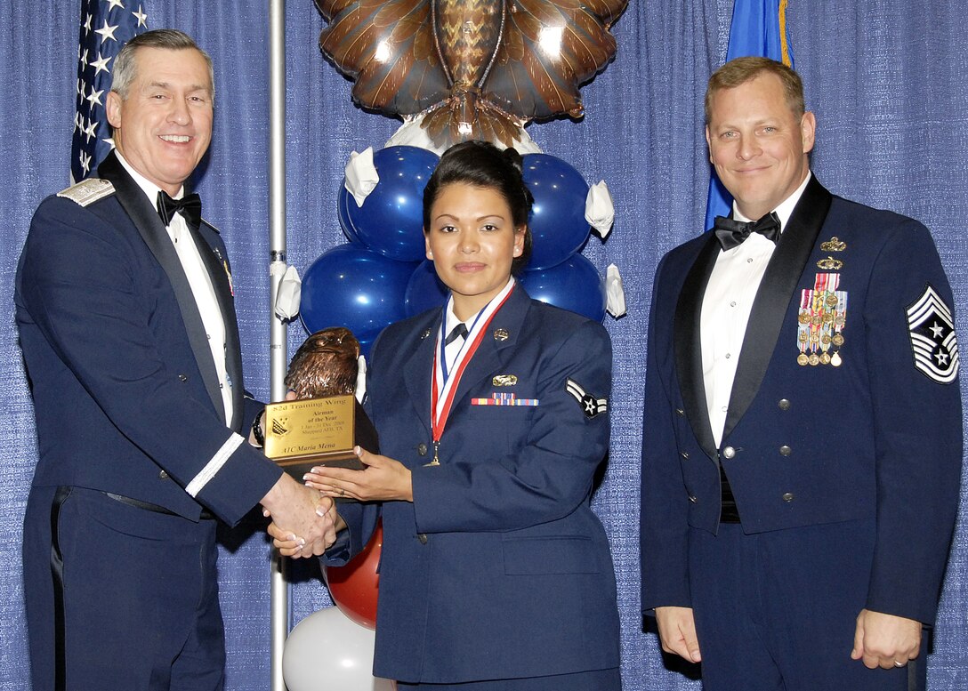 Airman 1st Class Maria Mena, 82nd Training Wing, accepts the Supervisory Civilian of the Year award on Feb. 13 from 82nd Training Wing Commander Brig. Gen. O.G. Mannon during the Annual Awards Banquet at the Multi Purpose Event Center. Also pictured is 82nd TRW Command Chief Master Sgt. Kenneth Sallinger. (U.S. Air Force photo/Lou Anne Sledge) 