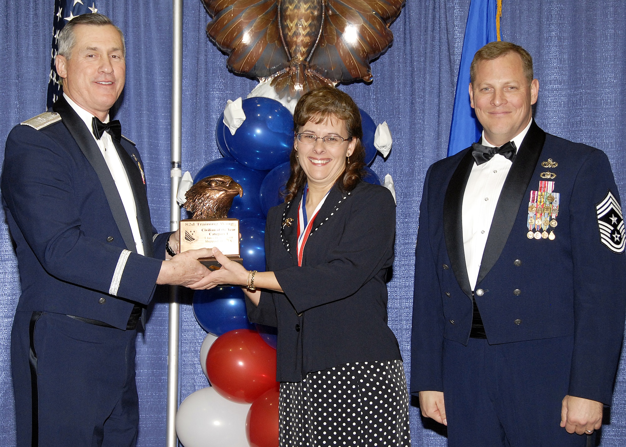 Marta Garcia, 82nd Medical Group, accepts the Civilian of the Year, Catagory I award on Feb. 13 from 82nd Training Wing Commander Brig. Gen. O.G. Mannon during the Annual Awards Banquet at the Multi Purpose Event Center. Also pictured is 82nd TRW Command Chief Master Sgt. Kenneth Sallinger. (U.S. Air Force photo/Lou Anne Sledge) 