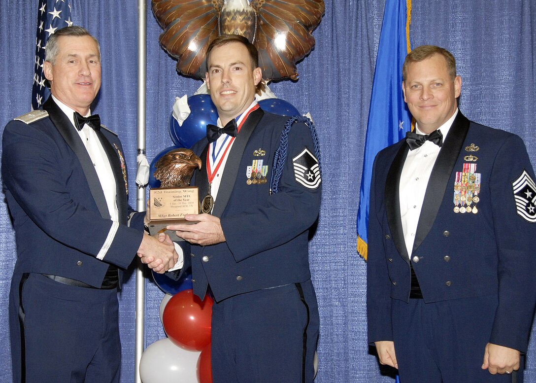 Master Sgt. Robert Fraley, 82nd Training Wing, accepts the Senior Military Training Leader of the Year award on Feb. 13 from 82nd Training Wing Commander Brig. Gen. O.G. Mannon during the Annual Awards Banquet at the Multi Purpose Event Center. Also pictured is 82nd TRW Command Chief Master Sgt. Kenneth Sallinger. (U.S. Air Force photo/Lou Anne Sledge) 
