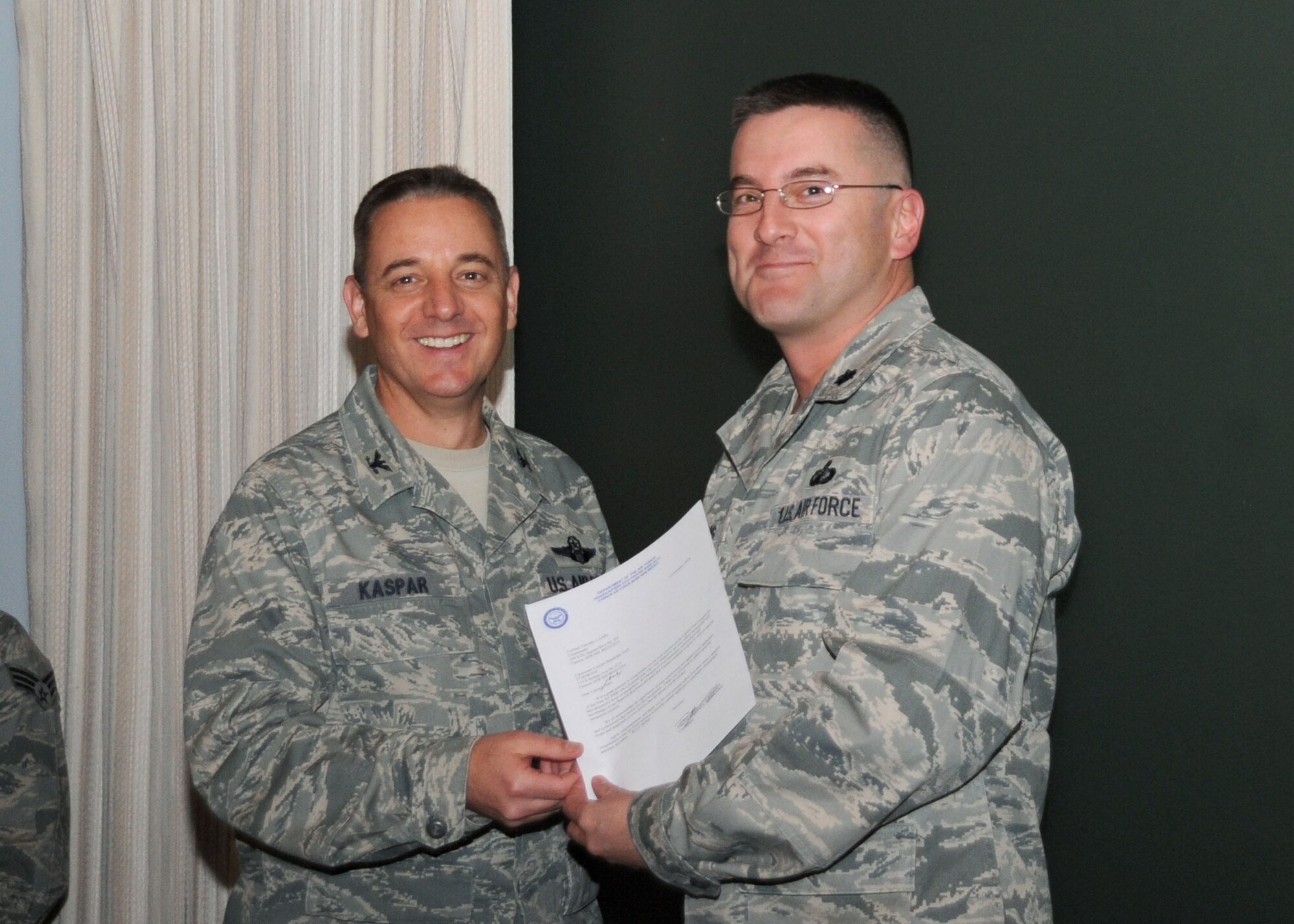CANNON AIR FORCE BASE, N.M.-- Col. Hans Kaspar, 27th Special Operations Wing vice commander, awards Lt. Col. Randy Toris, 27th Special Operations Comptroller Squadron commander, the 2008 United States Special Operations Command Comptroller of the Year award. Colonel Toris received the award at a weekly wing staff meeting on Feb. 17. (U.S. Air Force photo by Airman Maynelinne De La Cruz)