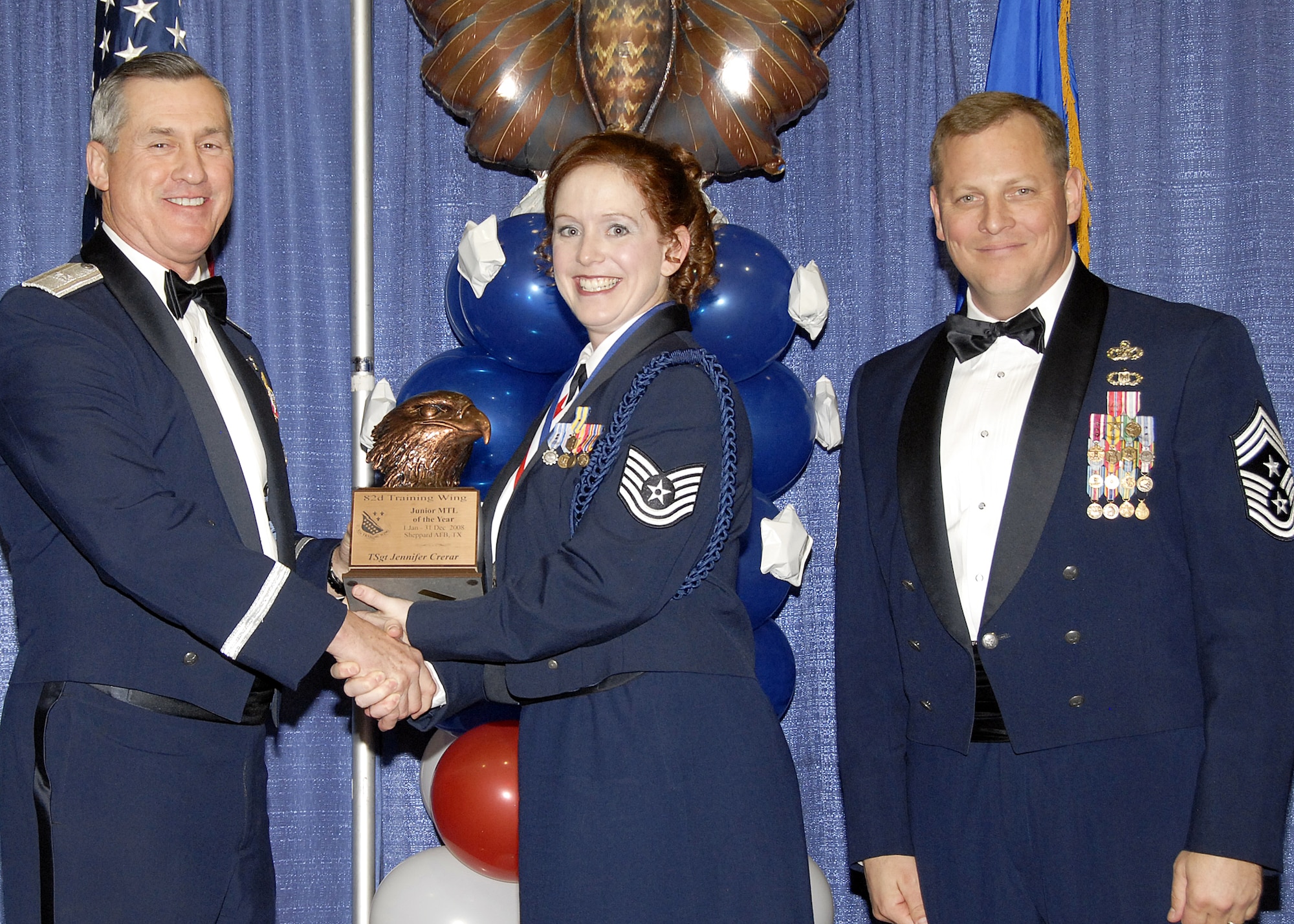 Tech. Sgt. Jennifer Crerar, 82nd Training Wing, accepts the Junior Military Training Leader of the Year award on Feb. 13 from 82nd Training Wing Commander Brig. Gen. O.G. Mannon during the Annual Awards Banquet at the Multi Purpose Event Center. Also pictured is 82nd Training Wing Command Chief Master Sgt. Kenneth Sallinger. (U.S. Air Force photo/Lou Anne Sledge) 