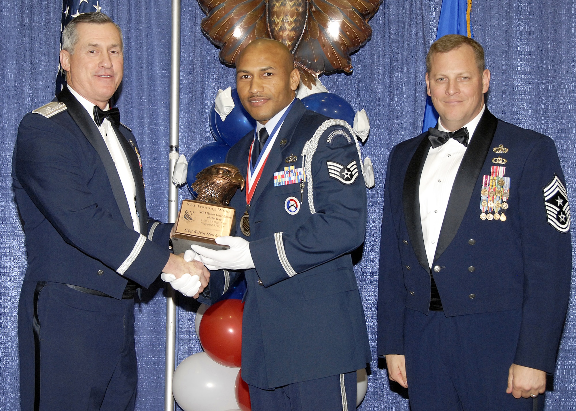 Staff Sgt. Kelvin Hatcher, 782nd Training Group, accepts the NCO Honor Guardsman of the Year award on Feb. 13 from 82nd Training Wing Commander Brig. Gen. O.G. Mannon during the Annual Awards Banquet at the Multi Purpose Event Center. Also pictured is 82nd Training Wing Command Chief Master Sgt. Kenneth Sallinger. (U.S. Air Force photo/Lou Anne Sledge) 