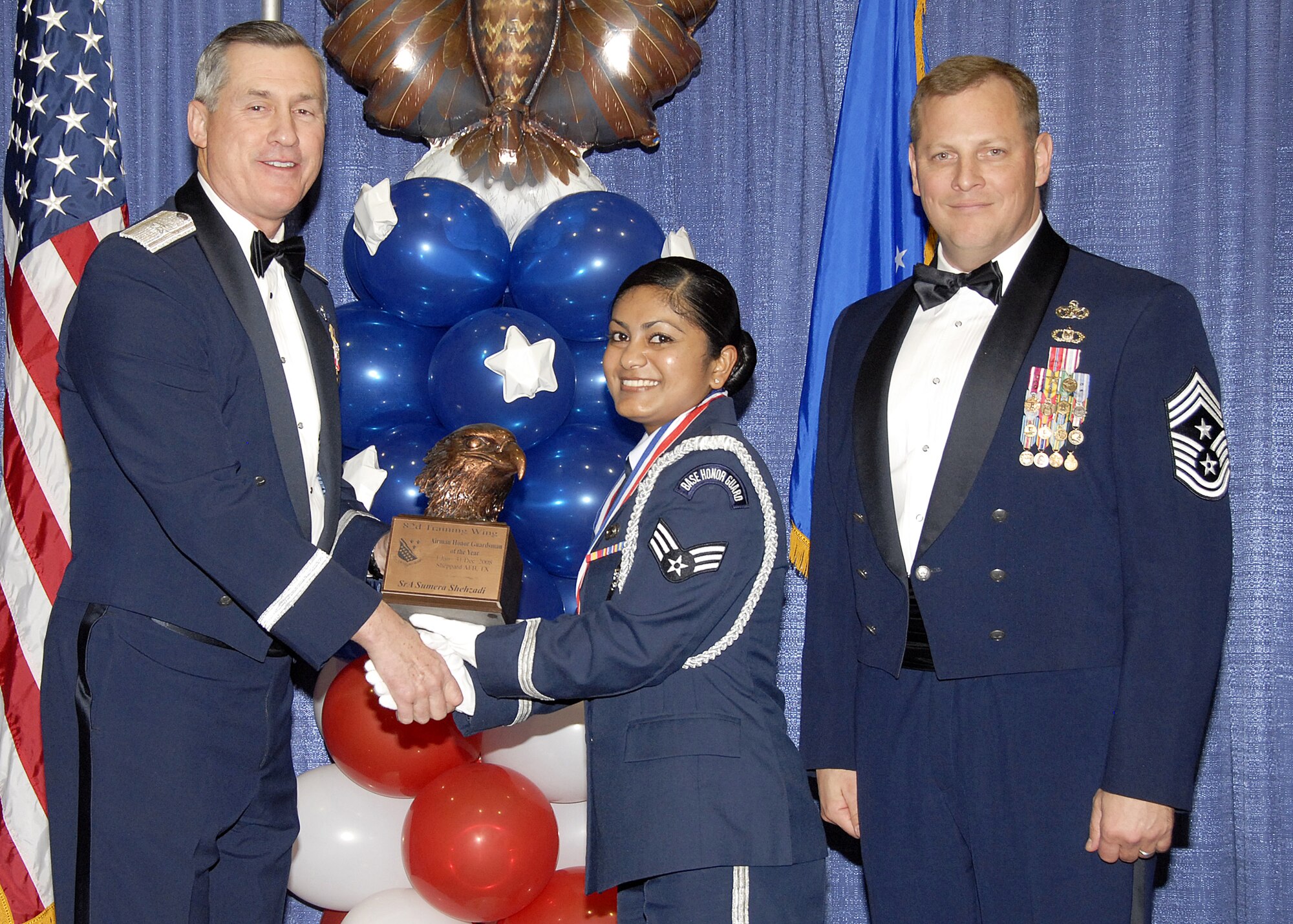 Senior Airman Sumera Shehzadi, 82nd Mission Support Group, accepts the Airmen Honor Guardsman of the Year award on Feb. 13 from 82nd Training Wing Commander Brig. Gen. O.G. Mannon during the Annual Awards Banquet at the Multi Purpose Event Center. Also pictured is 82nd Training Wing Command Chief Master Sgt. Kenneth Sallinger. (U.S. Air Force photo/Lou Anne Sledge) 