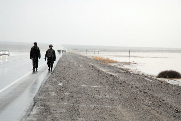 Airmen with the 95th Security Forces Squadron walk along Rosamond Boulevard during the 2nd Joyner Invitational challenge Feb. 16. The 9.1-mile march started at the West Gate and ended at the top of Red Hill. (Air Force photo by Senior Airman Julius Delos Reyes)