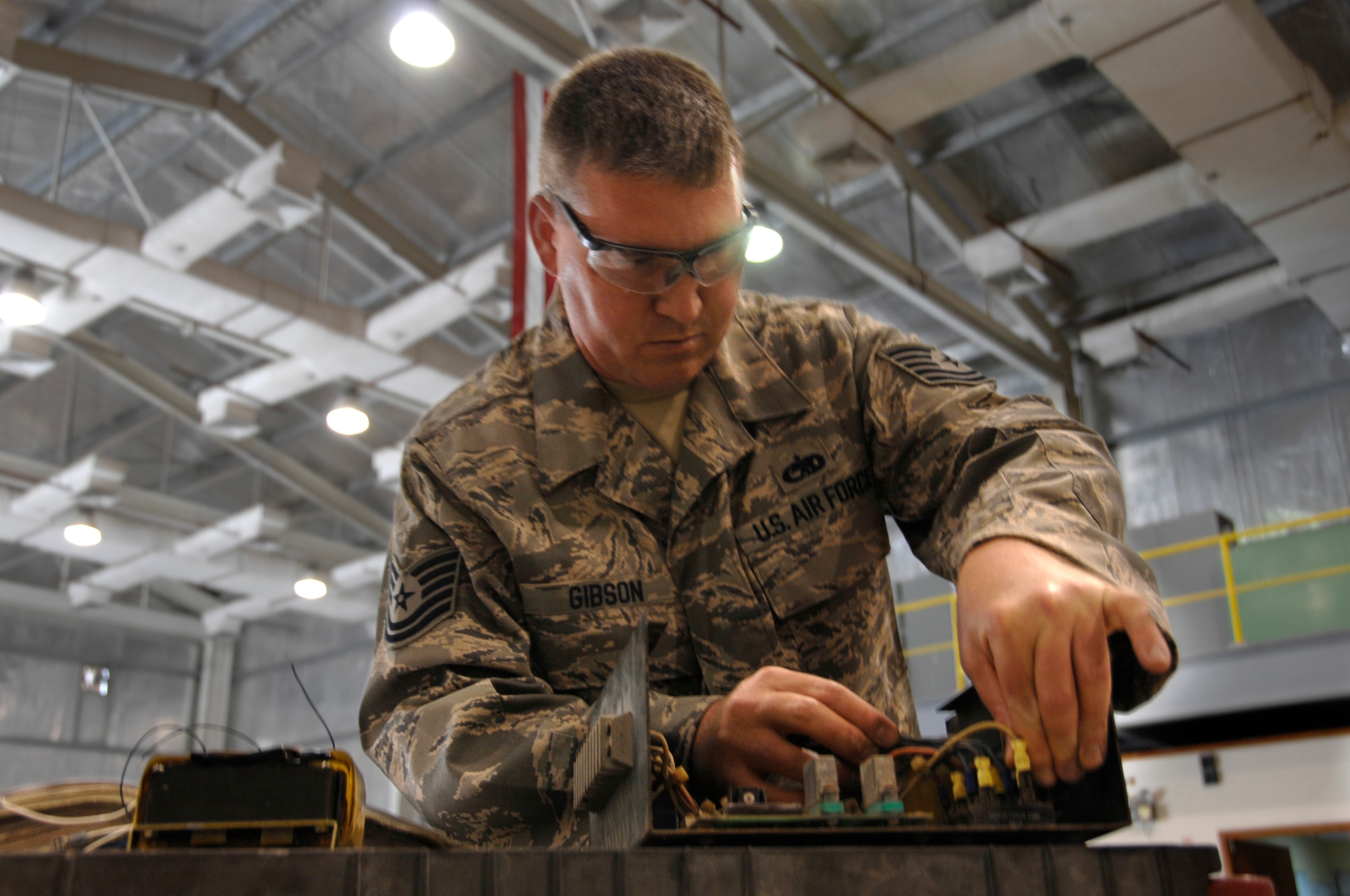 Tech. Sgt. Chad Gibson, replacing a transformer in a generator battery charging system, is participating in the 380th Air Expeditionary Wing's Body Mass Reduction Program at an air base in Southwest Asia. He started his deployment weighing 233 pounds at 72 inches tall, giving him a body mass index of 31.5. His goal is to drop to 205 pounds which would give him a BMI of 27.7.  Sergeant Gibson is the aerospace ground equipment Shift 2 supervisor in the 380th Expeditionary Maintenance Squadron.  (U.S. Air Force photo/Staff Sgt. Mike Andriacco)