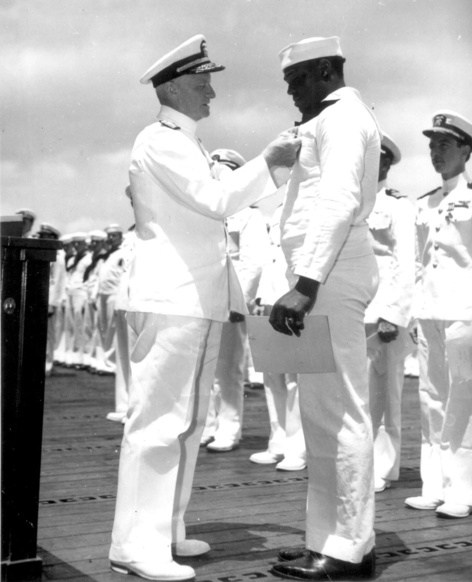 Doris Miller was commended by the Secretary of the Navy Frank Knox on April 1, 1942, and on May 27, 1942 he received the Navy Cross, which Fleet Admiral (then Admiral) Chester W. Nimitz, the Commander in Chief, Pacific Fleet personally presented to Miller on-board aircraft carrier USS Enterprise (CV-6) for his extraordinary courage in battle. (Courtesy Photo)