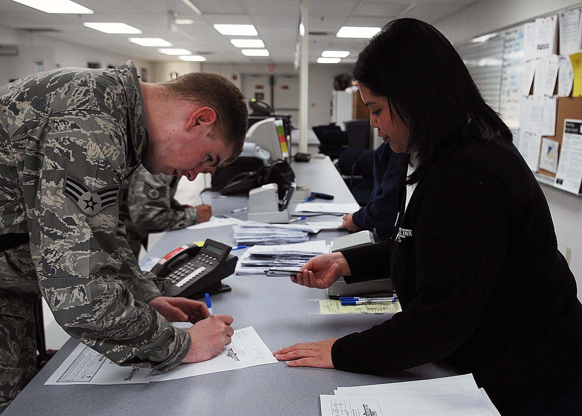 Ms. Audrey Balajadia, Lodging personnel, 49th Force Support Squadron, assists transients from Elmendorf Air Force Base, Alaska, on Feb. 17. Military personnel assigned to the 3rd Maintenance Group will stay at Holloman Air Force Base, N.M., until the volcanic activity observed at Mount Redoubt near Elmendorf subsides.

 (U.S. Air Force photo/SSgt Anthony Nelson Jr)