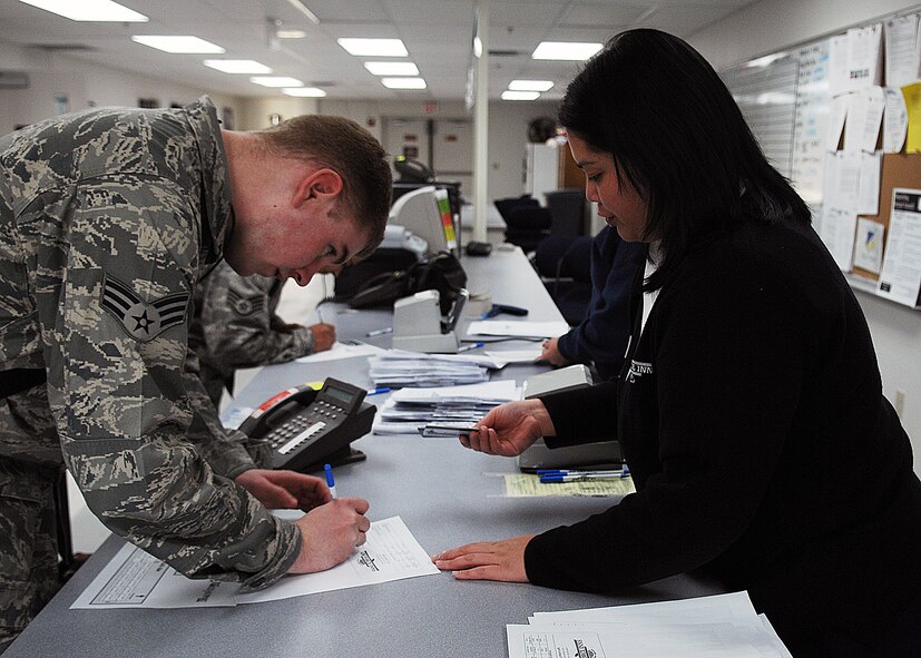 Ms. Audrey Balajadia, Lodging personnel, 49th Force Support Squadron, assists transients from Elmendorf Air Force Base, Alaska, on Feb. 17. Military personnel assigned to the 3rd Maintenance Group will stay at Holloman Air Force Base, N.M., until the volcanic activity observed at Mount Redoubt near Elmendorf subsides. (U.S. Air Force photo/SSgt Anthony Nelson Jr)