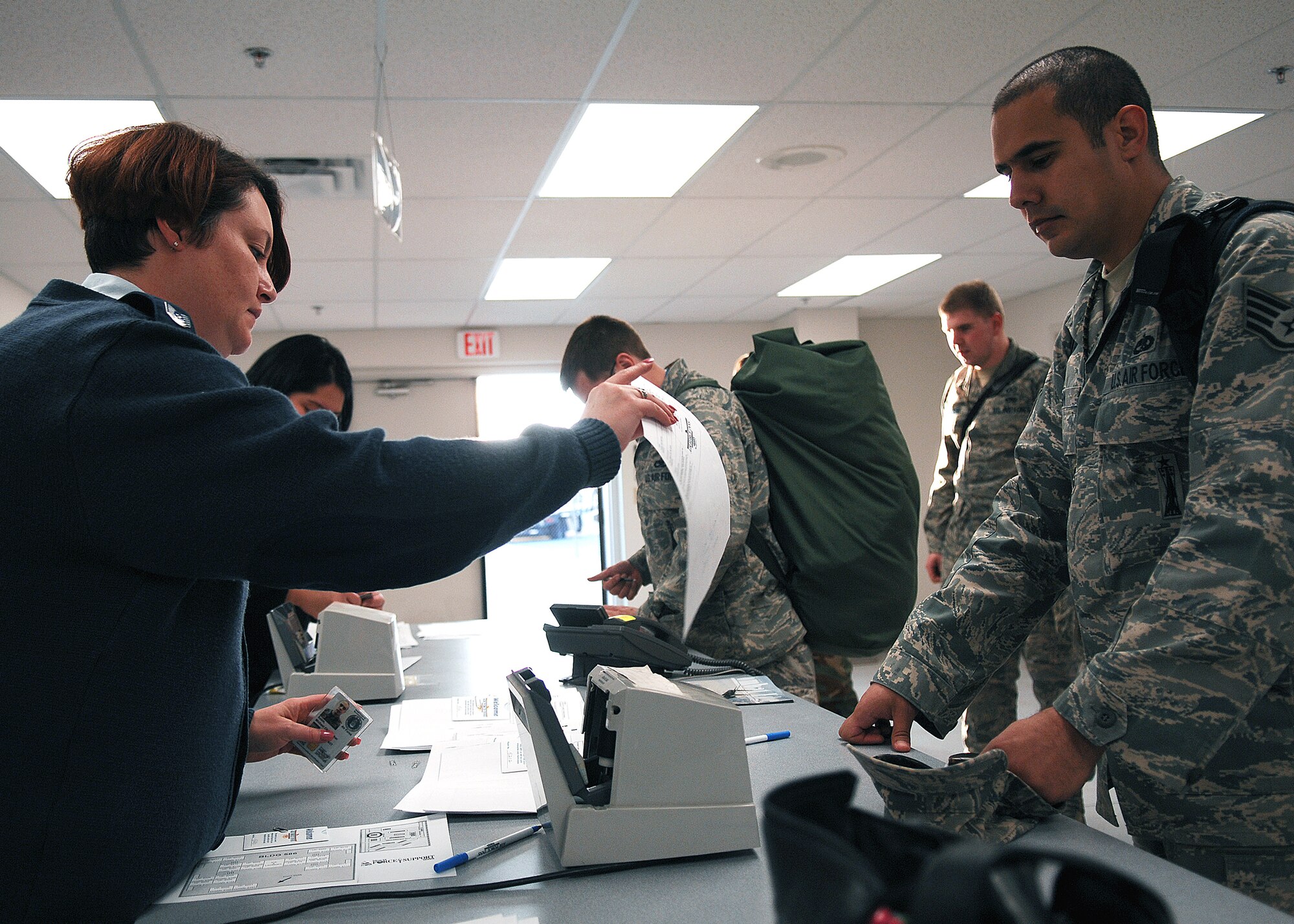 Tech Sgt. Carreen Beard, Lodging supervisor, 49th Force Support Squadron, assists transients from Elmendorf Air Force Base, Alaska, on Feb. 17. Military personnel assigned to the 3rd Maintenance Group will stay at Holloman Air Force Base, N.M. until the volcanic activity observed at Mount Redoubt near Elmendorf subsides.

 (U.S. Air Force photo/SSgt Anthony Nelson Jr)