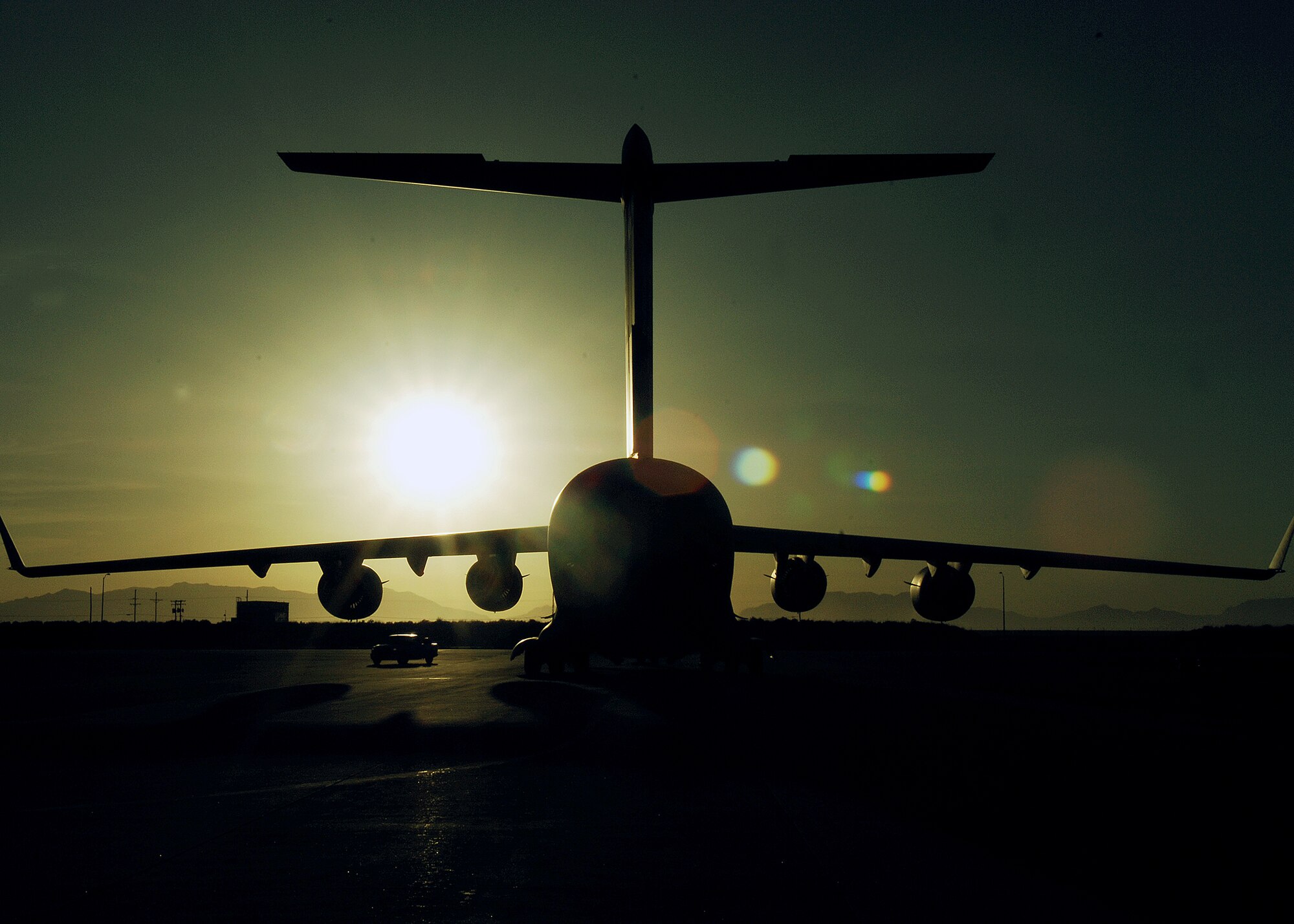 A C-17 sits on the ramp Feb. 17, next to Holloman Air Force Base's Basic Expeditionary Airfield Resources (BEAR) base. The C-17 is from Elmendorf AFB, Alaska, personnel and aircraft assigned to the 3rd Maintenance Group will stay at Holloman until the volcanic activity observed at Mount Redoubt near Elmendorf subsides.

 (U.S. Air Force photo/SSgt Anthony Nelson Jr)