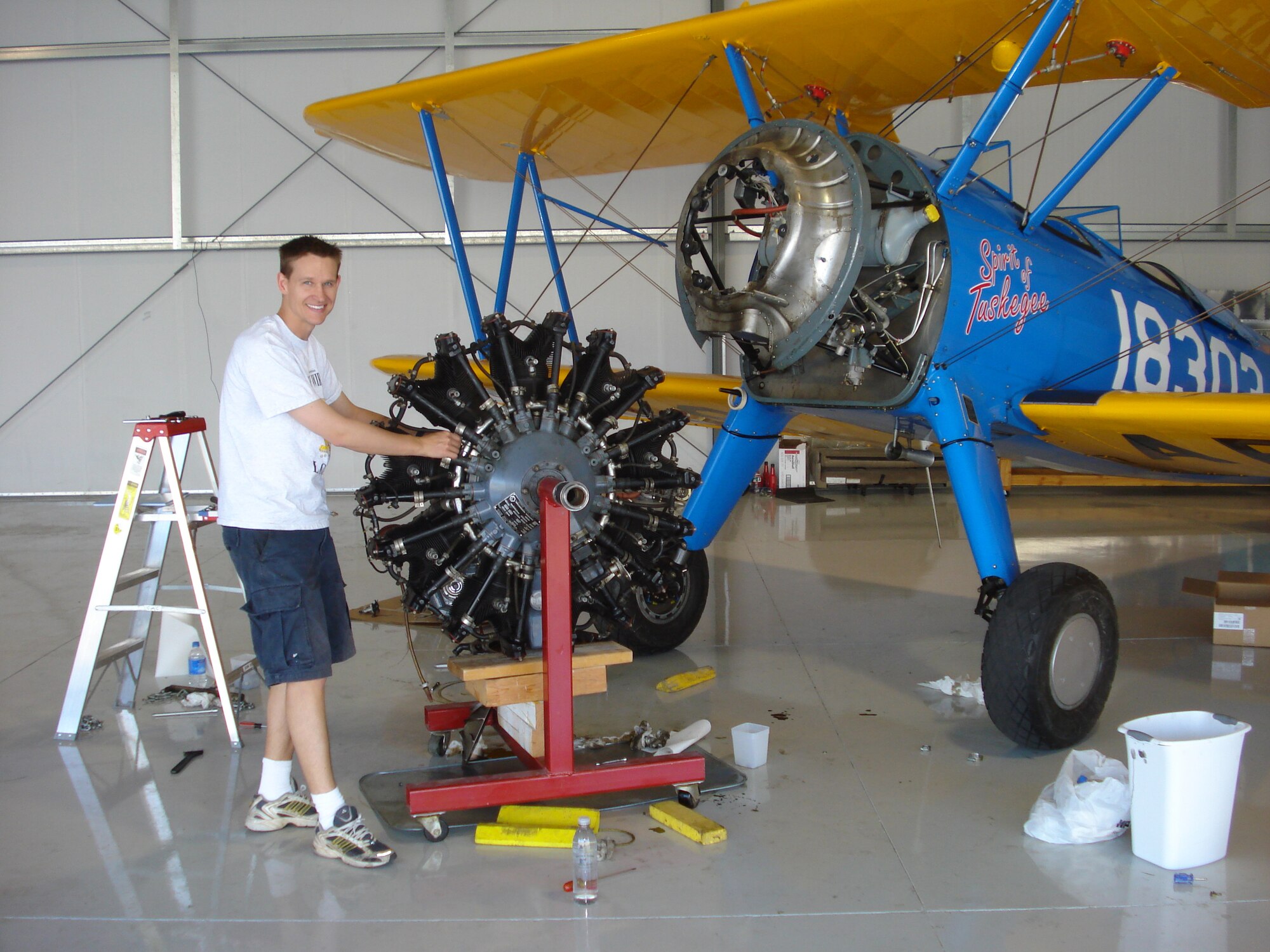 Capt. Matthew Quy, a pilot from Creech Air Force Base, Nev., repairs the engine of his Boeing Stearman PT-13.  The Stearman was used as a primary trainer by the Army Air Corps during World War II. Thousands of pilots, including the Tuskegee Airmen, learned to fly behind the controls of the PT-13.
(courtesy photo)
