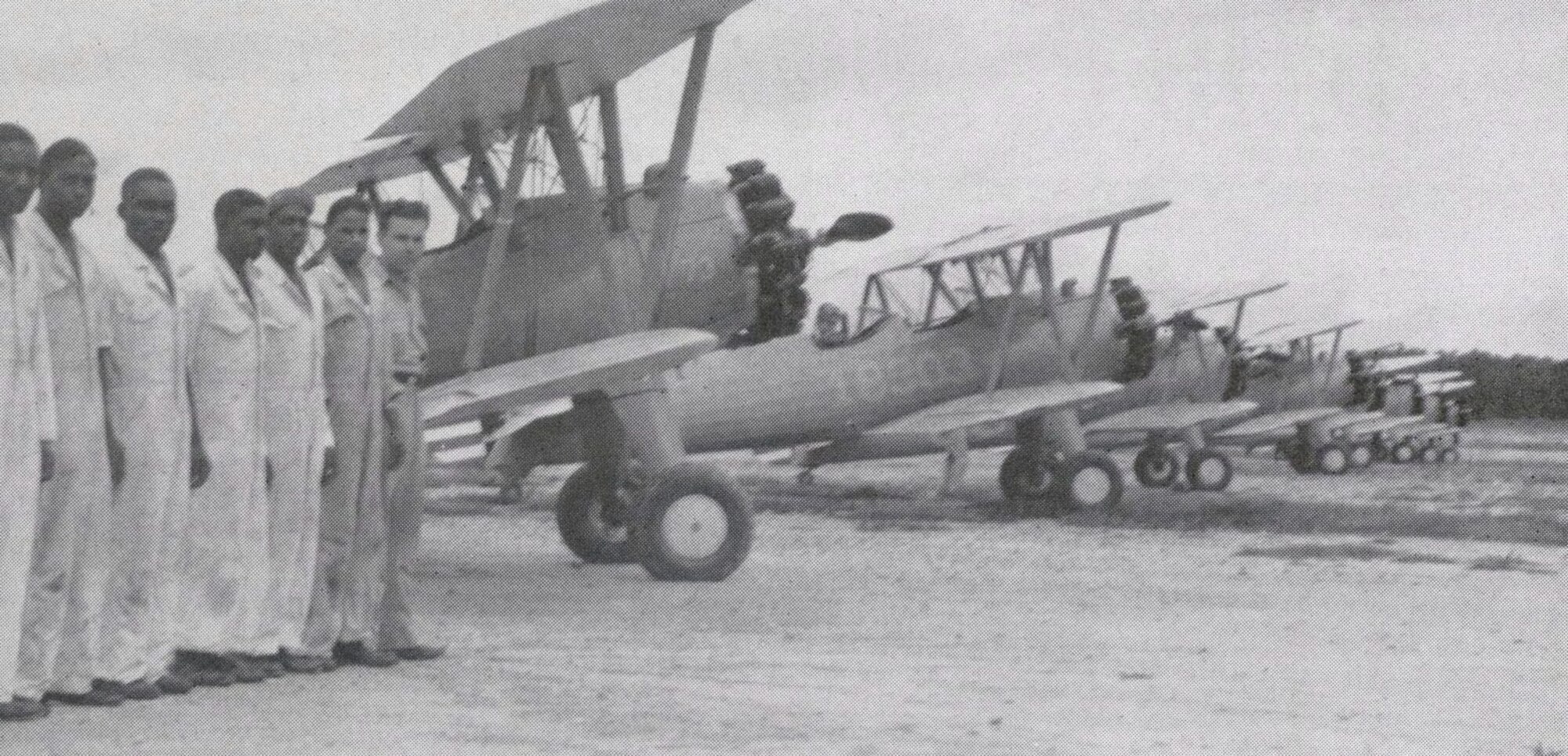 Tuskegee Airmen form up on the flight line in Tuskegee, Ala. in front of of Boeing Stearman PT-13s, during World War II. The Army Air Corps used the Stearmans as a primary trainer to teach fledging pilots basic flying skills before they moved onto higher-performance aircraft. 
(courtesy photo)