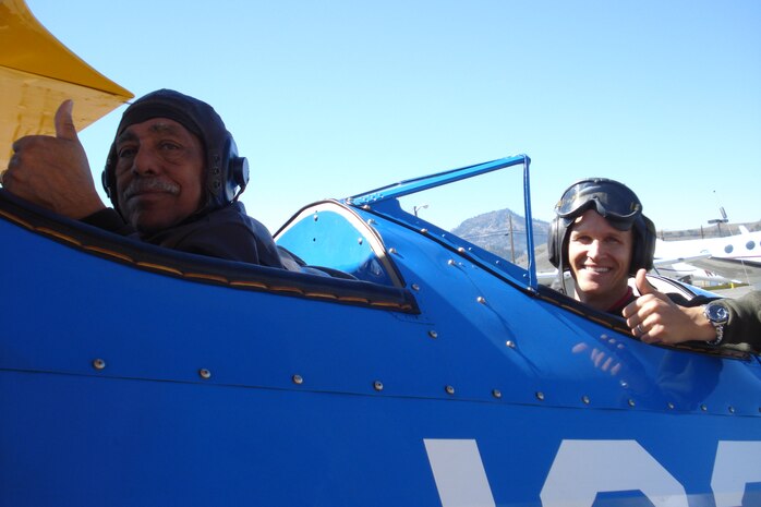 Retired Lt. Col. Bill Holloman, a Tuskegee Airman and fighter pilot in World War II and the Korean War,left, and Capt. Matthew Quy, a pilot from Creech Air Force Base, Nev., prepare for take off in Captain Quy’s restored World War II era Boeing Stearman PT-13 trainer. This was Colonel Holloman’s first flight in a Stearman since his pilot training approximately 60 years earlier. Captain Quy said Colonel Holloman flew the plane like it was yesterday. 
(courtesy photo)