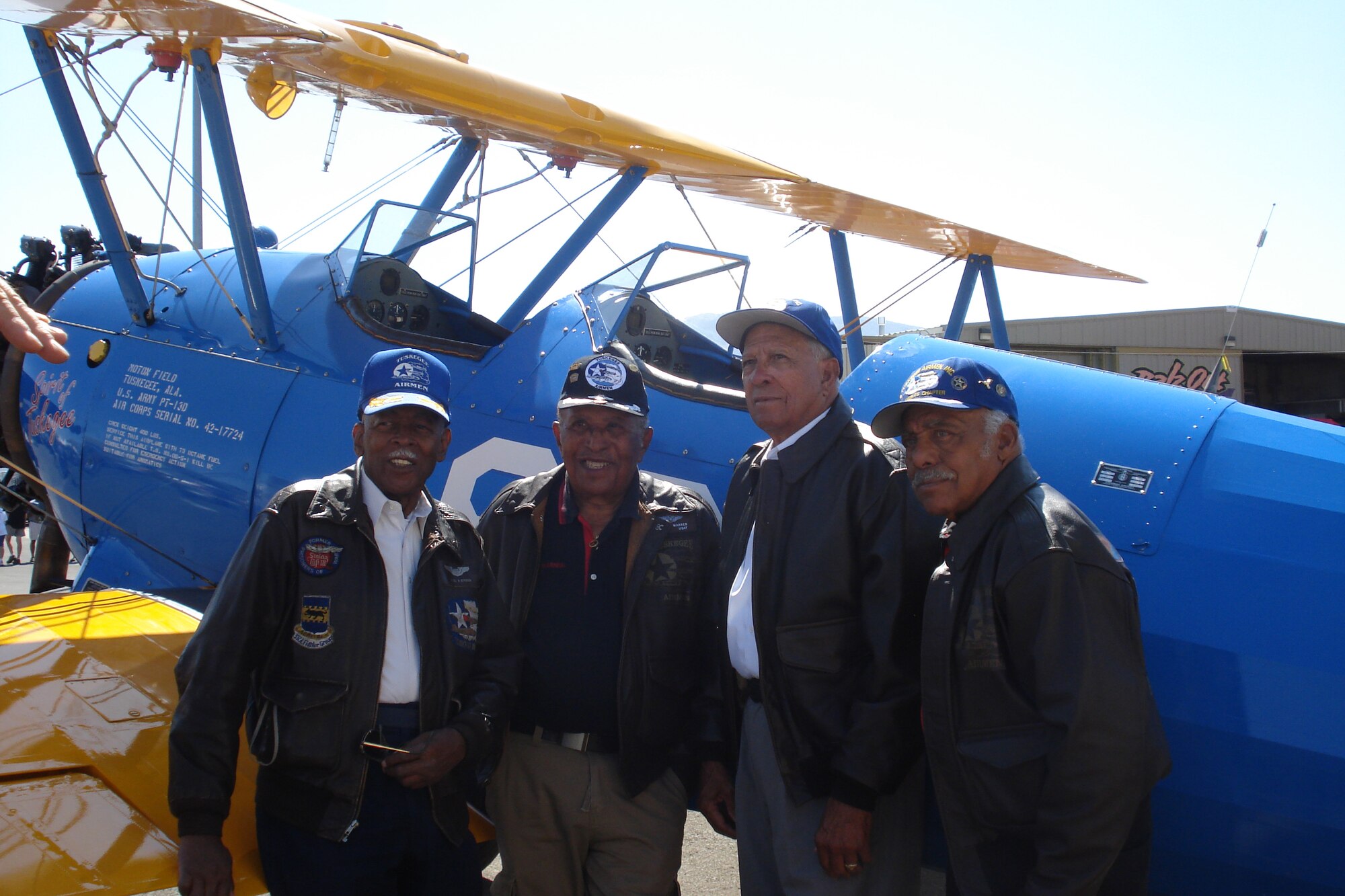 Four Tuskegee Airmen were reunited with the Boeing Stearman PT-13 at a show in Reno, Nev., last September.  (left to right) Retired Lt. Col. Alexander Jefferson, a World War II pilot and prisoner-of-war; Retired Lt. Col. James Warren, a navigator and bombardier in World War II, the Korean War and Vietnam War; Lt. Rusty Burns, a fighter pilot during World War II and Retired Lt. Col. Bill Holloman, a fighter pilot in World War II and the Korean War. All four Airmen had a chance to fly in the Stearman. 
(courtesy photo)