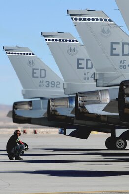 Robert Macadoo, weapons specialist with the 416th Flight Test Squadron at Edwards Air Force Base, Calif, performs pre-flight inspections on F-16 Fighting Falcons in support of Red Flag 09-2 Feb 4 at Nellis Air Force Base, Nev. Red Flag is a multi-national exercise providing a realistic environment to practice combat scenarios. The experience gained during the exercise is vital to the survival of air crews in combat. (Air Force photo by Senior Airman Nadine Y. Barclay)