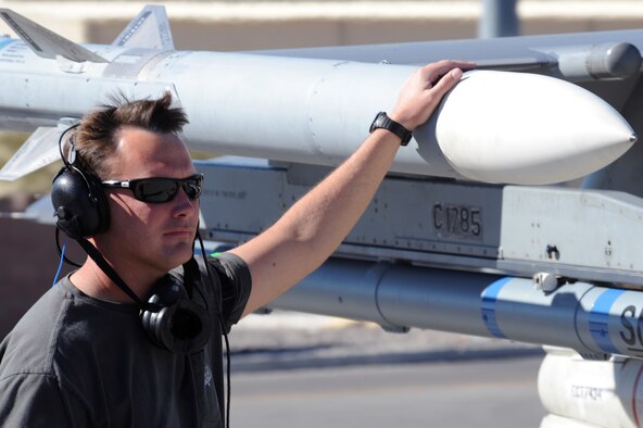 Dan Carter, 416th Flight Test Squadron crew chief for the F-16 Flighting Falcon, runs a maintenance check on an F-16 Fighting Falcon Feb. 4 during Red Flag at Nellis Air Force Base, Nev. The 416th Flight Test Squadron from Edwards is the first Air Force Materiel Command unit to participate in the exercise. (Air Force photo by Airman First Class Brett C. Clashman)