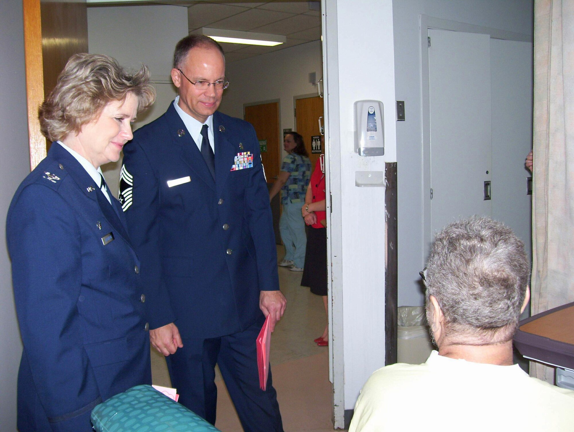 Col. Amy Bachelor (left) and Chief Master Sgt. John Gervais visit with hospitalized veterans Feb. 13 at Audie L. Murphy Memorial Veterans Hospital, in San Antonio, as part of the Valentines for Vets program. Colonel Bachelor is the 59th Inpatient Operations Group commander. Chief Gervais is assigned to the 59th Medical Support Group. (U.S. Air Force photo/Linda Frost) 
