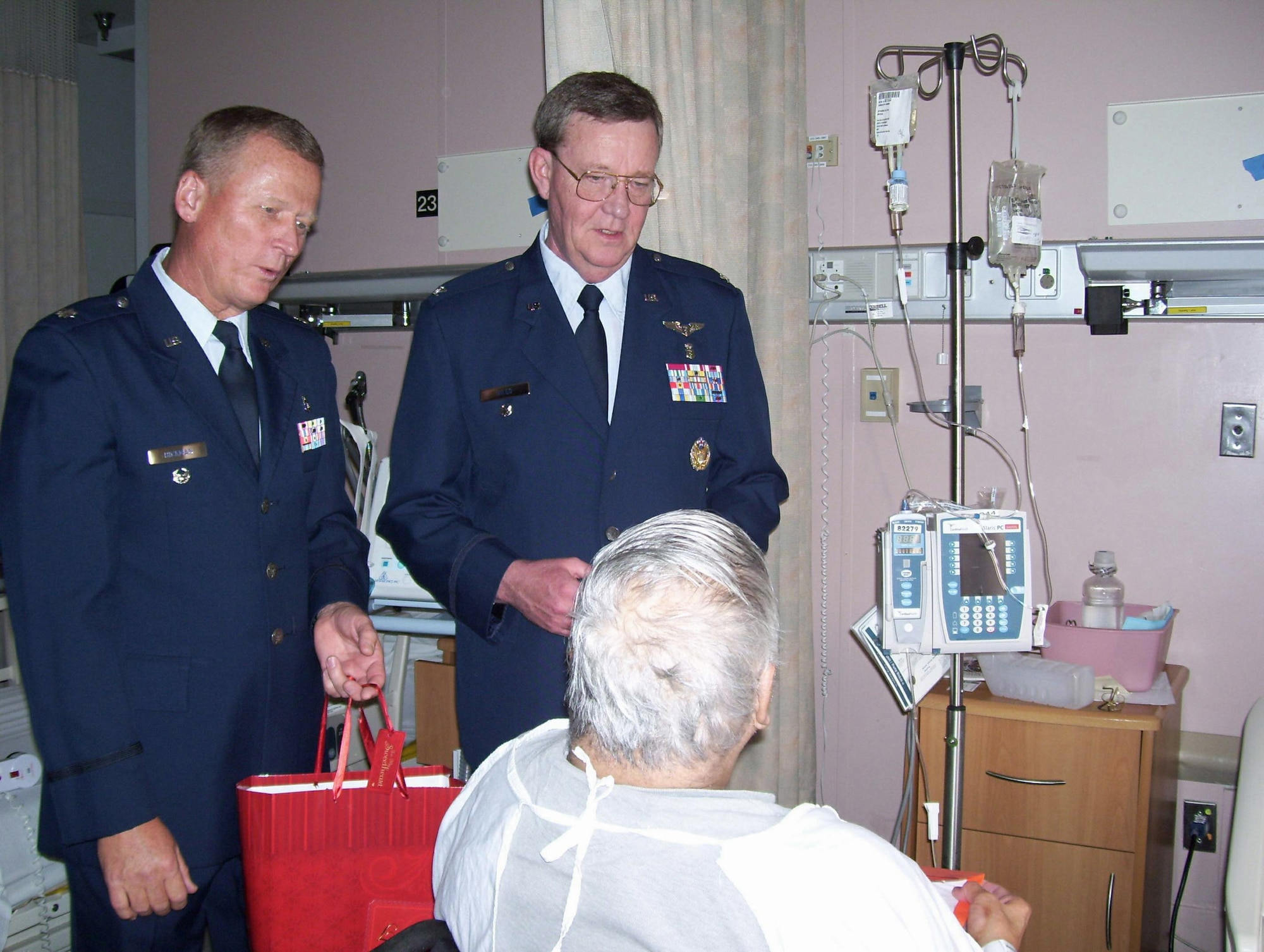 Lt. Col. John Hickman (left) and Col. Stephen Niles, senior leaders at Wilford Hall Medical Center at Lackland Air Force Base, Texas, visited with veterans Feb 13. at Audie L. Murphy Memorial Veterans Hospital, in San Antonio, as part of the annual Valentine's for Vets program. The salute to veterans is a time set aside to recognize the sacrifices veterans have made for their country and to increase community awareness of the medical centers' programs. (U.S. Air Force photo/Linda Frost) 

