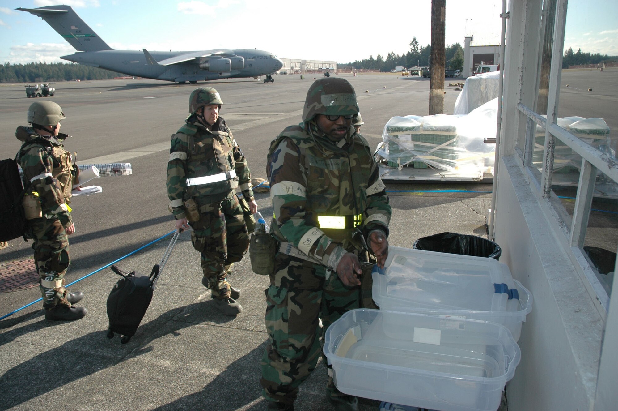 Reservists participating in the February mobility exercise at McChord Air Force Base, Wash., decontaminate at a simulated decon station before entering their work place. (U.S. Air Force photo/Staff Sgt. Grant Saylor)