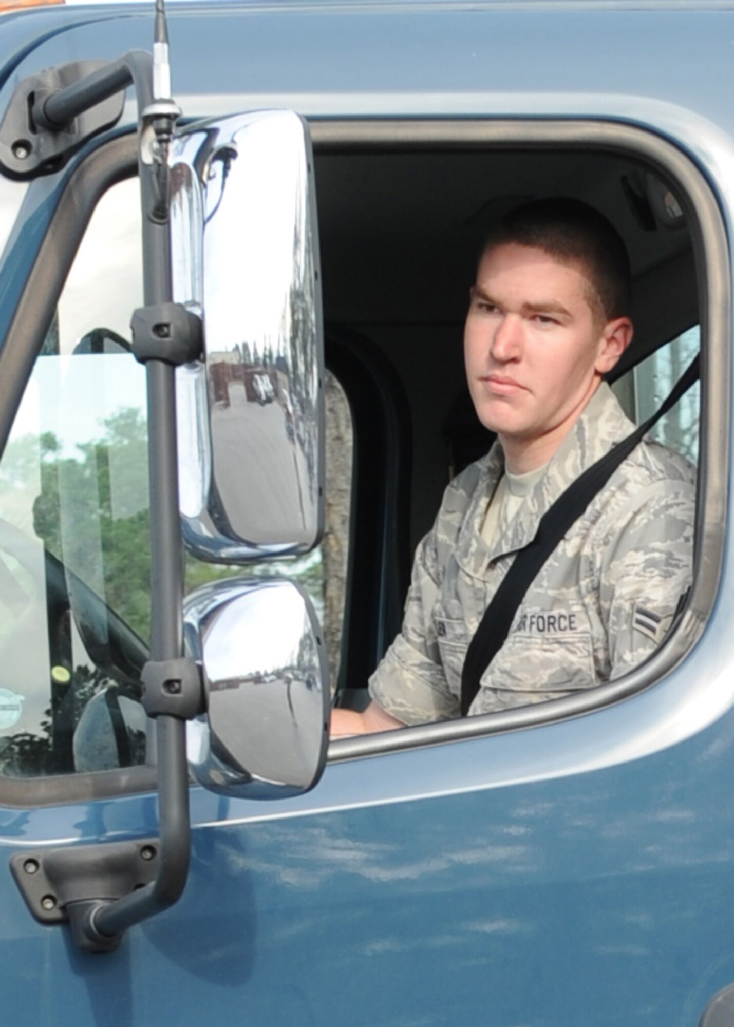 Airman 1st Class Christopher Miller, Combat Vehicle Operations Flight here, looks in the mirror to make sure he clears the corner on Seymour Johnson Air Force Base, N.C., Feb. 11, 2009. Airman Miller conducts proficiency training and ensures parts and supplies are ready for rapid, secure and efficient transport to 4FW F-15E Strike Eagles at a moment's notice. (U.S. Air Force photo by Airman 1st Class Whitney Stanfield)
