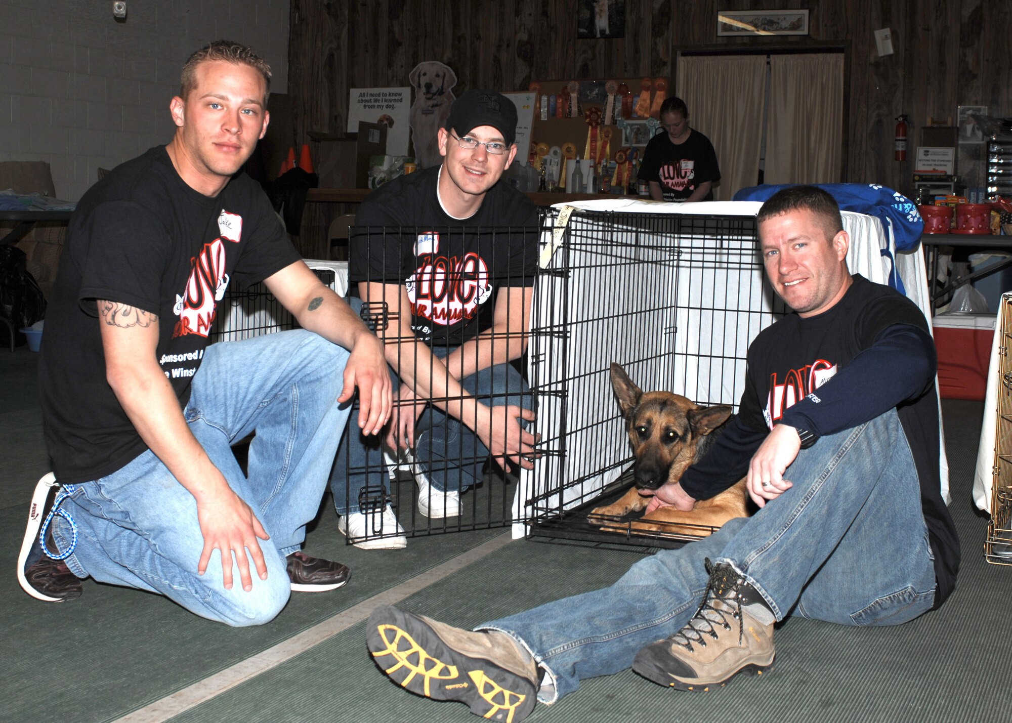 CANNON AIR FORCE BASE, N.M. -- (From left) Senior Airmen Jake Smith and Rodney Canary, 27th Special Operations Logistics Readiness Squadron, and Tech. Sgt. Mike Roxberry, 27th Special Operations Support Squadron, take a break during their volunteer efforts Feb. 14 during a spay and neuter event in Clovis, N.M. The  Airmen assisted with the more than 100 pets brought in for spaying, neutering and vaccinations. More than 30 Cannon families participated at a cost of $20 per pet. (Air Force photo by Greg Allen) 
