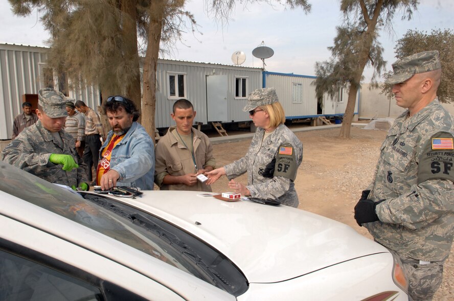 WRIGHT-PATTERSON AFB, Ohio – Tech Sgt. Michael Carley, 445th Airlift Wing Security Forces Squadron, assists other deployed security forces members as they perform an identification check. While deployed, security forces members perform duties including mobile patrol, quick reaction teams, tower guards, convoy and entry control point security (physical searches, credential checks and escort coordination).  (Courtesy photo)