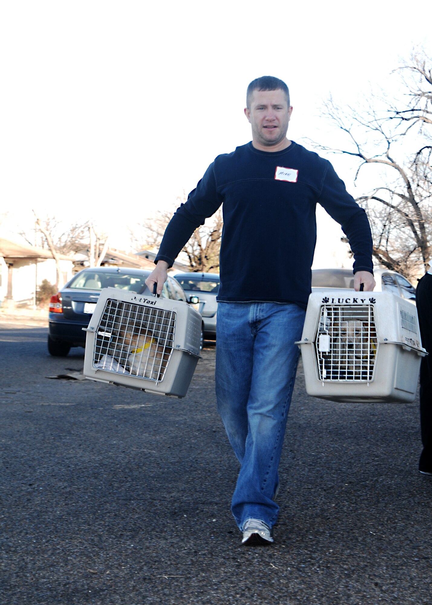 CANNON AIR FORCE BASE, N.M. --Tech. Sgt. Mike Roxberry, 27th Special Operations Support Squadron, carries dogs to the Santa Fe Animal Shelter and Humane Society van Feb. 16. Humane Society volunteers drove a mobile van to Clovis, N.M. to provide spaying and neutering services  and vaccinations  for $20 per pet for Clovis and Cannon Airmen pet owners Feb. 14-16. (Air Force photo by Greg Allen)
